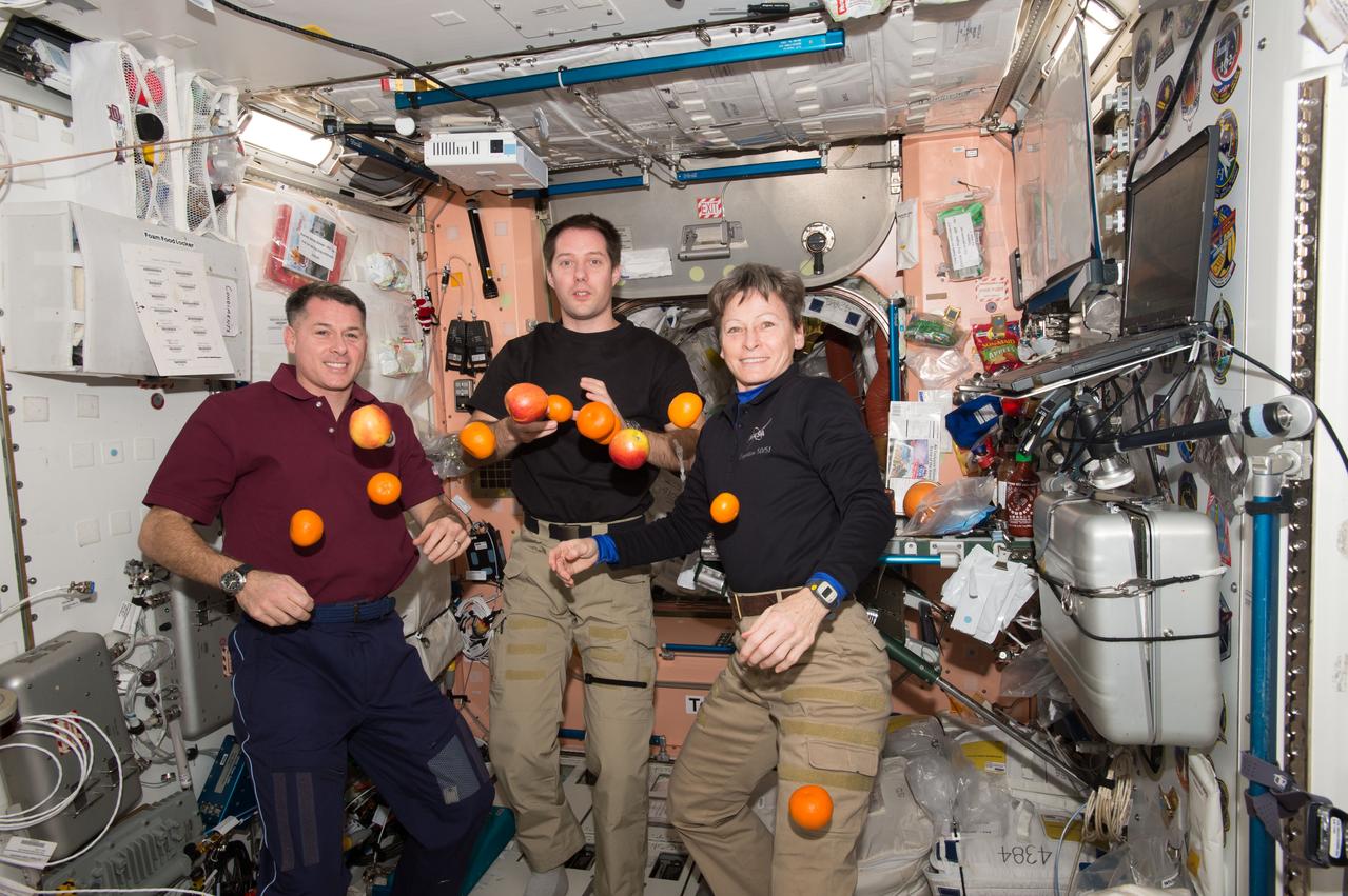 iss050e053700 (03/01/2017) --- Shane Kimbrough of NASA (left), Thomas Pesquet of ESA (European Space Agency) (middle) and Peggy Whitson of NASA (right) juggle some of the newly arrived fruit aboard the International Space Station. The fresh food was delivered on SpaceX’s tenth commercial resupply mission along with more than 5,600 pounds of supplies, science experiments and vehicle hardware.