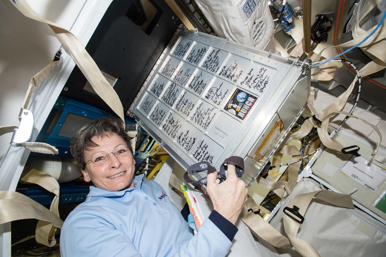 iss050e056553 (03/09/2017) --- NASA astronaut Peggy Whitson unloads spaceflight hardware delivered on SpaceX CRS-10 that was built as part of the NASA High School Students United with NASA to Create Hardware (HUNCH) program. Students in the HUNCH program receive valuable experience creating goods for NASA from hardware to the culinary arts, while NASA receives the creativity of the High School students.