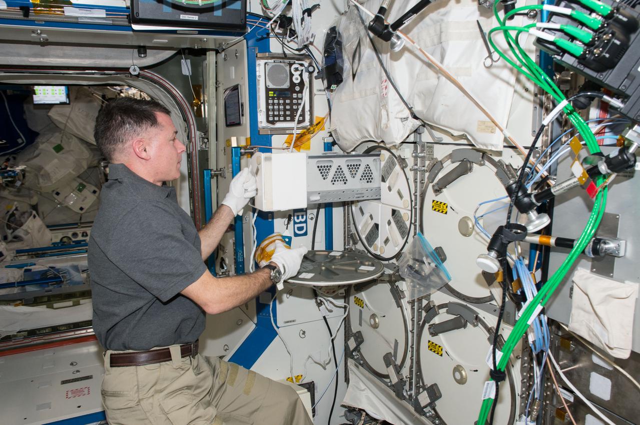 iss050e057428 (03/15/2017) --- NASA astronaut Shane Kimbrough removes a storage locker in the Minus Eighty-degree Laboratory Freezer for ISS (MELFI) to store samples from an experiment. MELFI is a cold storage unit that maintains experiment samples at ultra-cold temperatures throughout a mission.