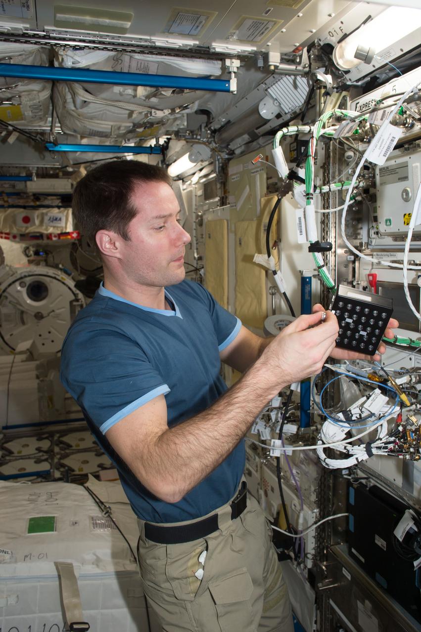 iss050e058802 (3/17/2017) --- A view of European Space Agency (ESA) astronaut Thomas Pesquet, during Protein Crystal Growth (PCG) -5 hardware deactivation and stow, from Microgravity Experiment Research Locker Incubator (MERLIN) on Expedite the Processing of Experiments to the Space Station (EXPRESS) Rack 5. The Microgravity Growth of Crystalline Monoclonal Antibodies for Pharmaceutical Applications (CASIS-PCG-5) investigation crystallizes a monoclonal antibody developed by Merck Research Labs. Microgravity enables the growth of extremely high-quality crystals, which allow scientists to study the proteins’ structure, improve drug delivery, manufacturing, and developing better methods for storing these biological molecules.
