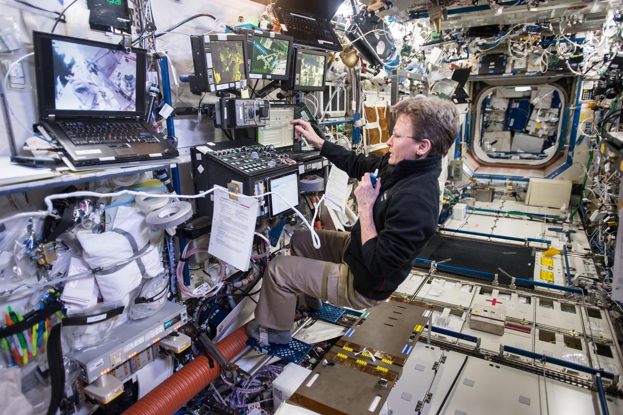 iss050e059608 (03/24/2017) --- NASA astronaut Peggy Whitson controls the robotic arm aboard the International Space Station during a spacewalk. Expedition 50 Commander Shane Kimbrough of NASA and Flight Engineer Thomas Pesquet of ESA (European Space Agency) conducted a six hour and 34 minute spacewalk on March 24, 2017. The two astronauts successfully disconnected cables and electrical connections on the Pressurized Mating Adapter-3 to prepare for its robotic move, lubricated the latching end effector on the Special Purpose Dexterous Manipulator “extension” for the Canadarm2 robotic arm, inspected a radiator valve and replaced cameras on the Japanese segment of the outpost.