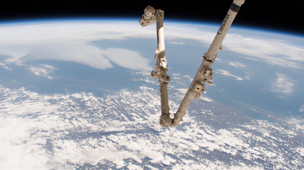 iss051e010470 (April 16, 2017) --- Canada's robotic arm, the Canadarm2, which is part of the Space Station Remote Manipulator System, is pictured with the Earth's limb in the background during a daytime orbital pass.