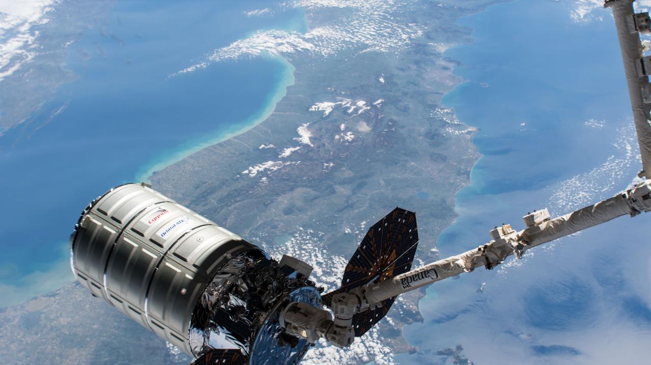 iss051e020059 (April 22, 2017) --- The Cygnus resupply ship from Orbital ATK is in the grips of the Canadarm2 robotic arm prior to its installation to the Unity module as the International Space Station orbited above Italy on April 22, 2017.