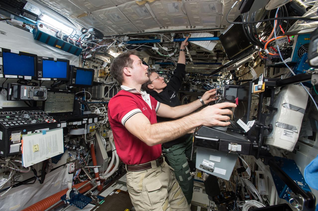 iss051e020157 (April 21, 2017) --- Expedition 51 Flight Engineer Thomas Pesquet (foreground) and Commander Peggy Whitson use the robotics work station in the Destiny laboratory module to practice capturing a resupply ship with the Canadarm2 robotic arm.