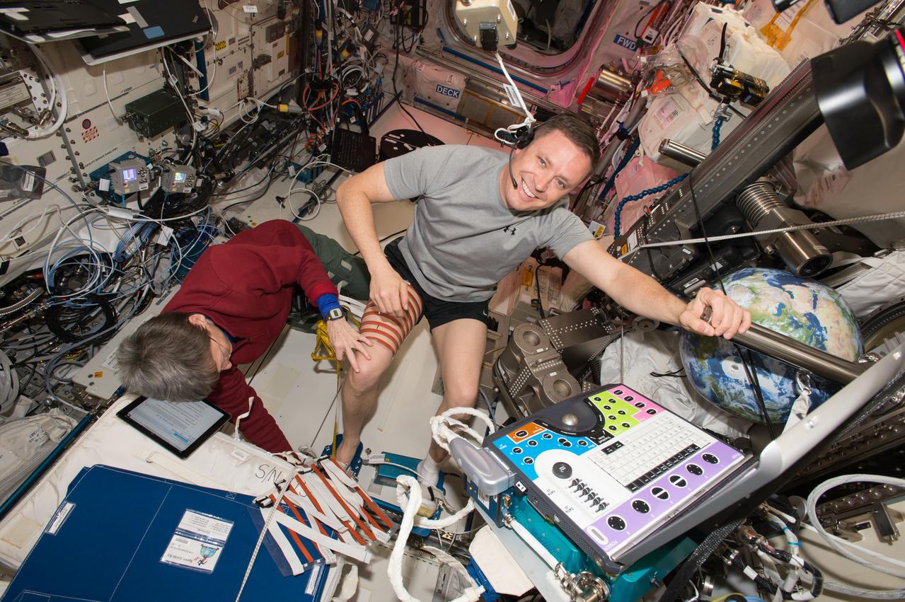 iss051e037012 (May 3, 2017) --- Flight engineer Jack Fischer dons Thigh and Calf Guides in preparation for Ultrasound 2 operations for the Integrated Resistance and Aerobic Training Study (Sprint) experiment. He is assisted by Commander Peggy Whitson. Image was taken in the Columbus European Laboratory.