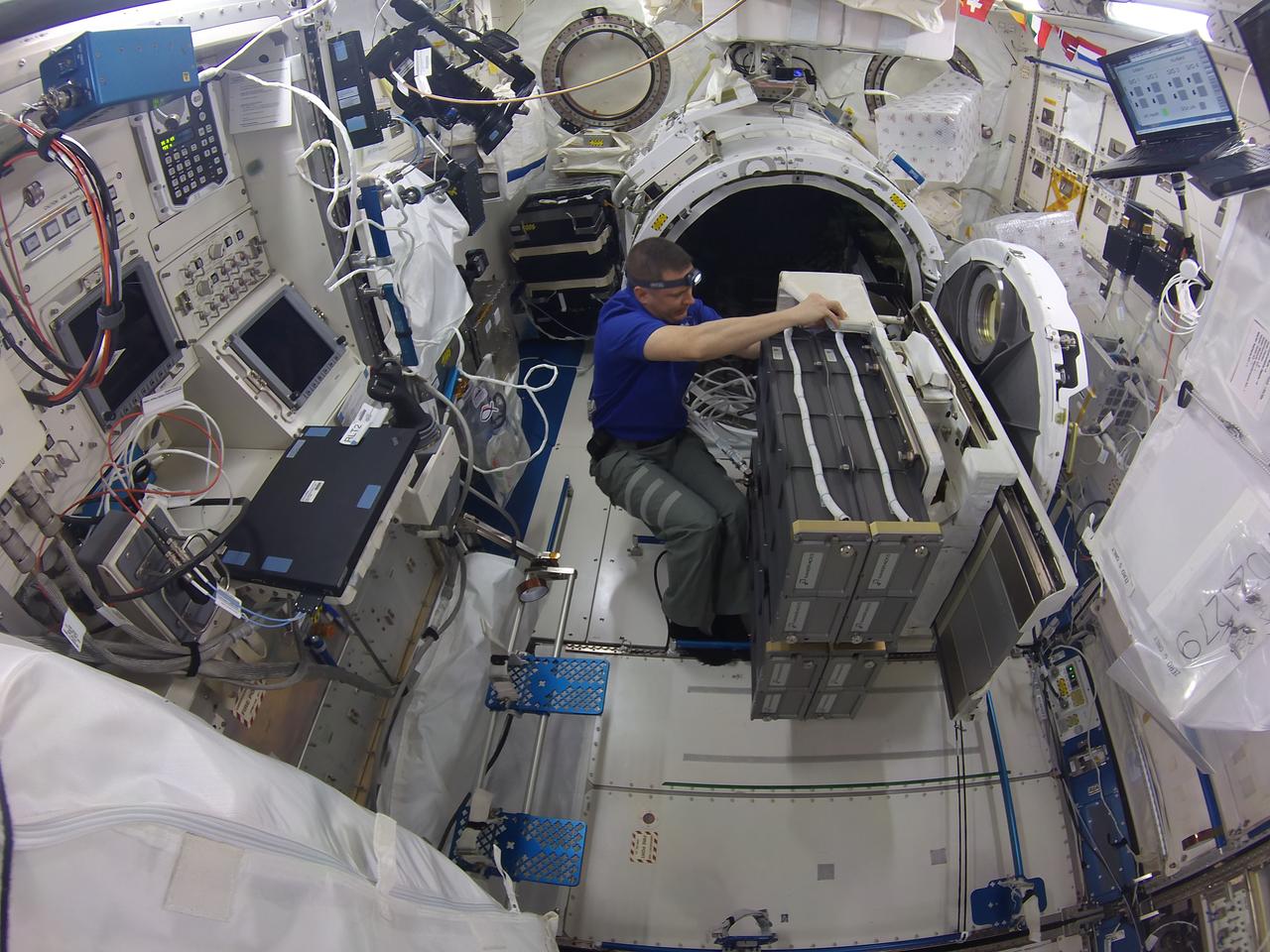 iss051e042749 (5/15/2017) -- NASA astronaut Jack Fischer loads the NanoRacks CubeSat Deployer in to an airlock in the Japanese Experiment Module on the International Space Station. When transferred to the outside of the station, ground crews took control, triggering deployment of the satellites into Earth orbit. Credits: NASA