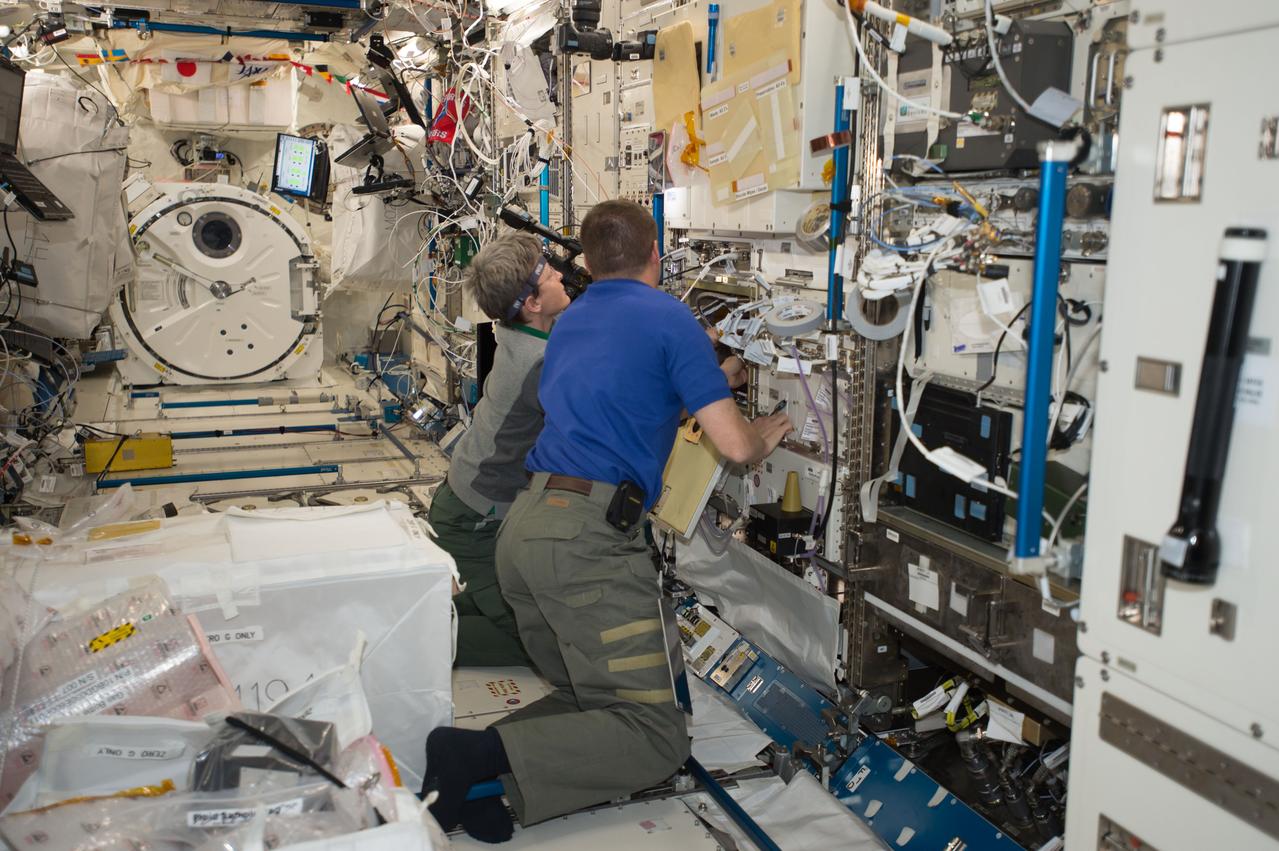 iss051e050850 (5/26/2017) --- NASA astronaut Peggy Whitson and Jack Fischer work to install a Gas Supply Hose Assembly and Gas Bottle Unit Air in the Electrostatic Levitation Furnace (ELF) in the Kibo Japanese Experiment Pressurized Module (JPM) aboard the International Space Station (ISS) in supprt of the Passive Thermal Flight Experiment.The Advanced Passive Thermal eXperiment (APTx) tests three advanced thermal management technologies. It demonstrates the in-space performance of each, an important step toward improving these technologies for use on future space exploration missions.