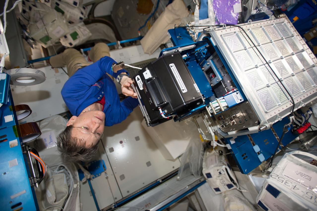 iss052e004180 (6/19/2017) --- Photo of NASA astronaut Peggy Whitson performing change out of Imaging Unit on the Bone Densitometer (BD) located in Node 2.