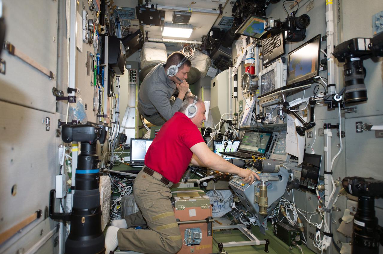 iss052e004331 (June 16, 2017) --- Expedition 52 crew members Fyodor Yurchikhin (middle foreground) and Jack Fischer were inside the Zvezda service module monitoring the docking of a Russian Progress 67 cargo ship on June 16, 2017.