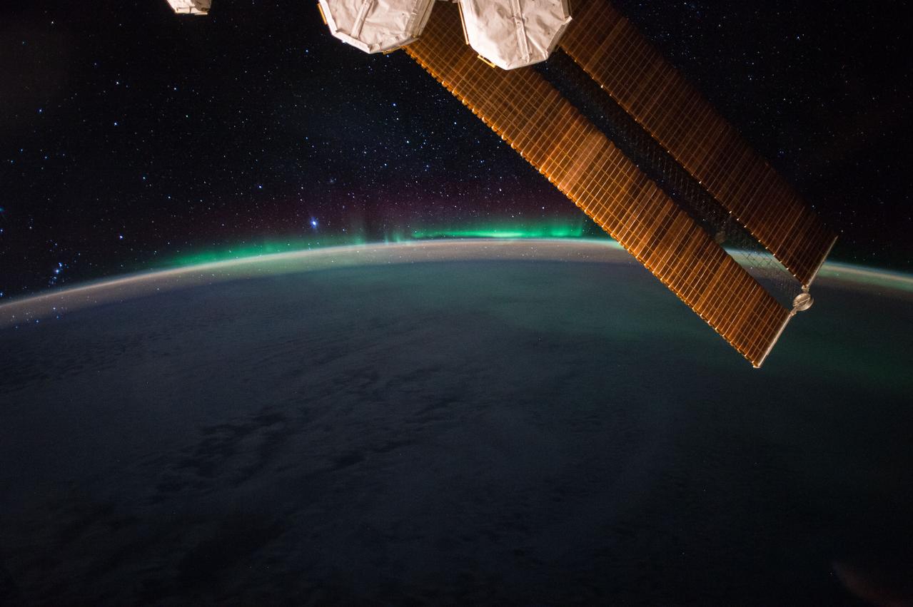 iss052e004913 (June 19, 2017) --- The aurora and the night sky above Earth’s atmosphere are pictured from the space station. A portion of the station’s solar arrays and a pair of nitrogen/oxygen recharge system tanks are pictured in the foreground.