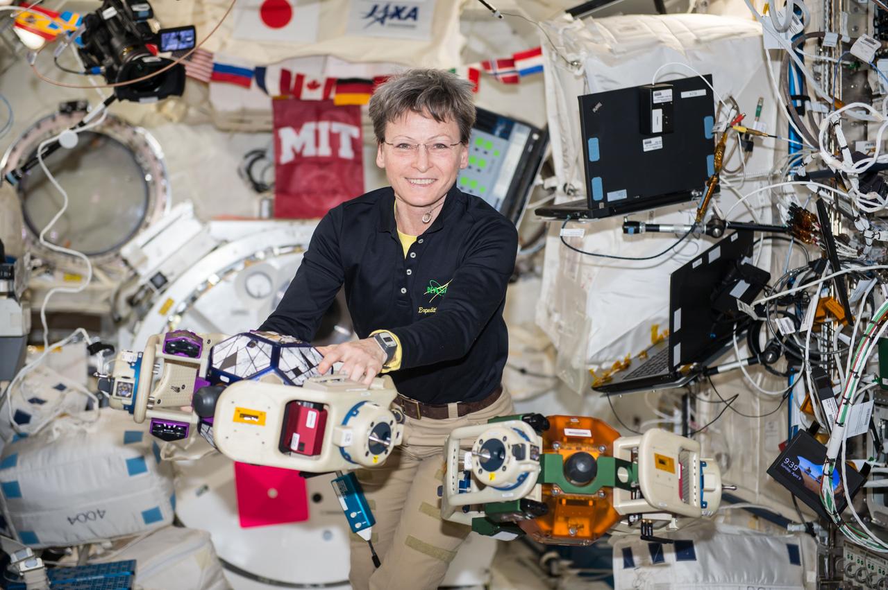iss052e006482 (6/23/2017) --- Astronaut Peggy Whitson is photographed during a test session of the Synchronized Position Hold, Engage, Reorient, Experimental Satellites (SPHERES) Halo investigation in the Kibo module. The SPHERES Halo investigation studies the possibility of launching several separate components and then attaching them once they are in space. The investigation upgrades the International Space Station’s fleet of SPHERES to enable each SPHERE to communicate with six external objects at the same time, testing new control and remote assembly methods.