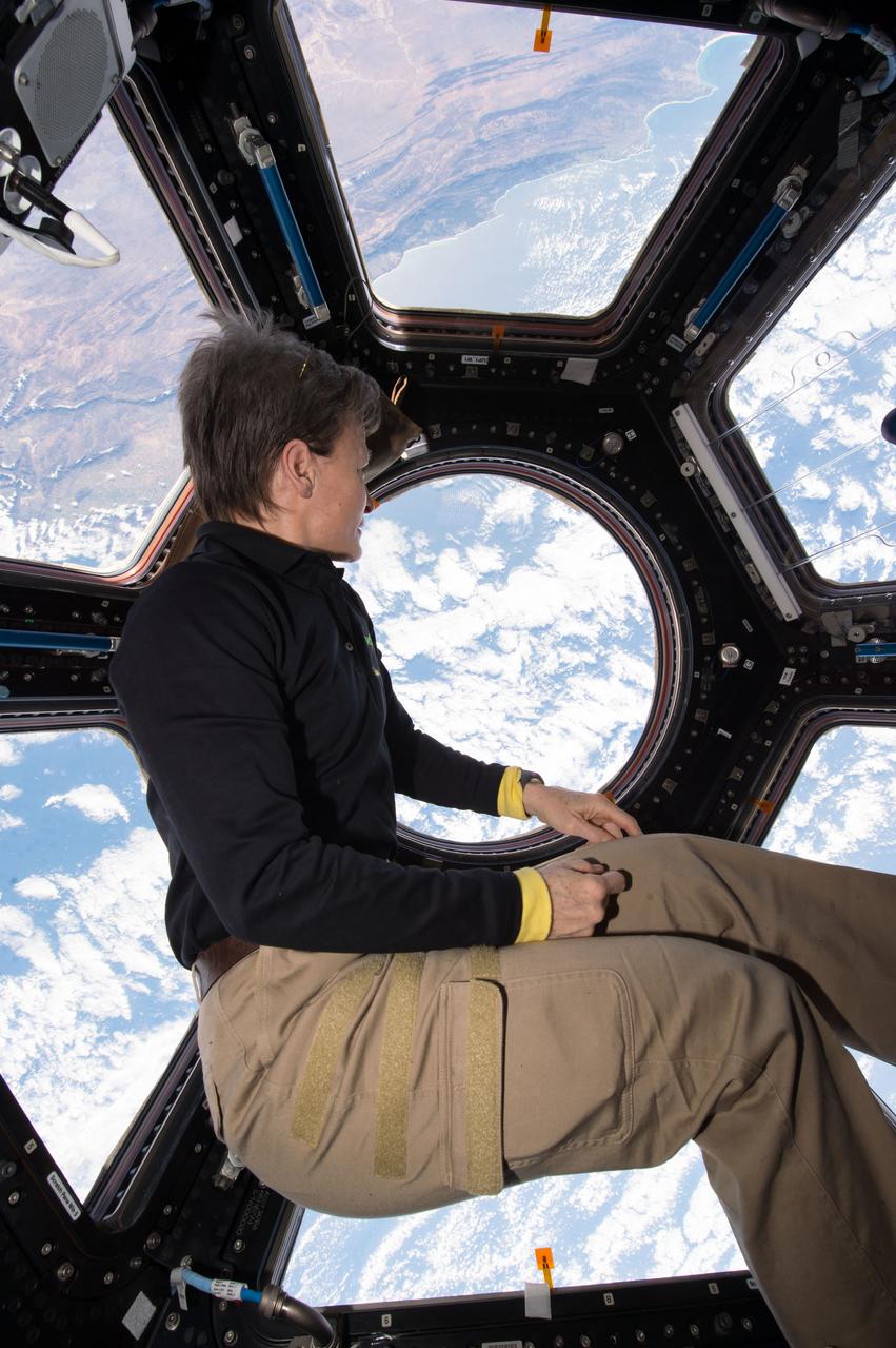 iss052e016190 (July 18, 2017) --- Astronaut Peggy Whitson is photographed sitting in front of the Cupola windows during the final Crew Autonomous Scheduling Test (CAST) session. The CAST investigation analyzes whether crews can develop plans in a reasonable period of time with appropriate input, whether proximity of planners to the planned operations increases efficiency, and if crew members are more satisfied when given a role in plan development.