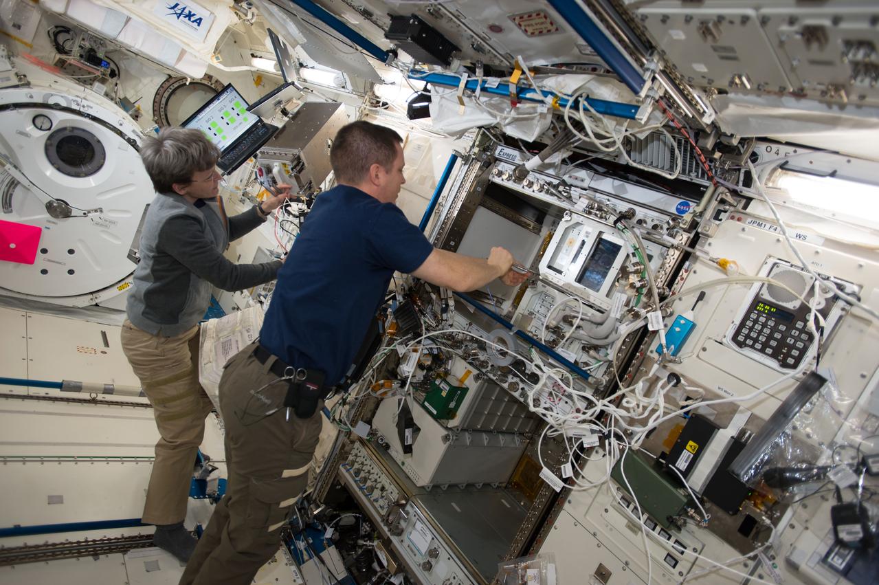 iss052e023844 (Aug. 1, 2017) --- Astronauts Peggy Whitson and Jack Fischer work on station systems inside Japan’s Kibo laboratory module.