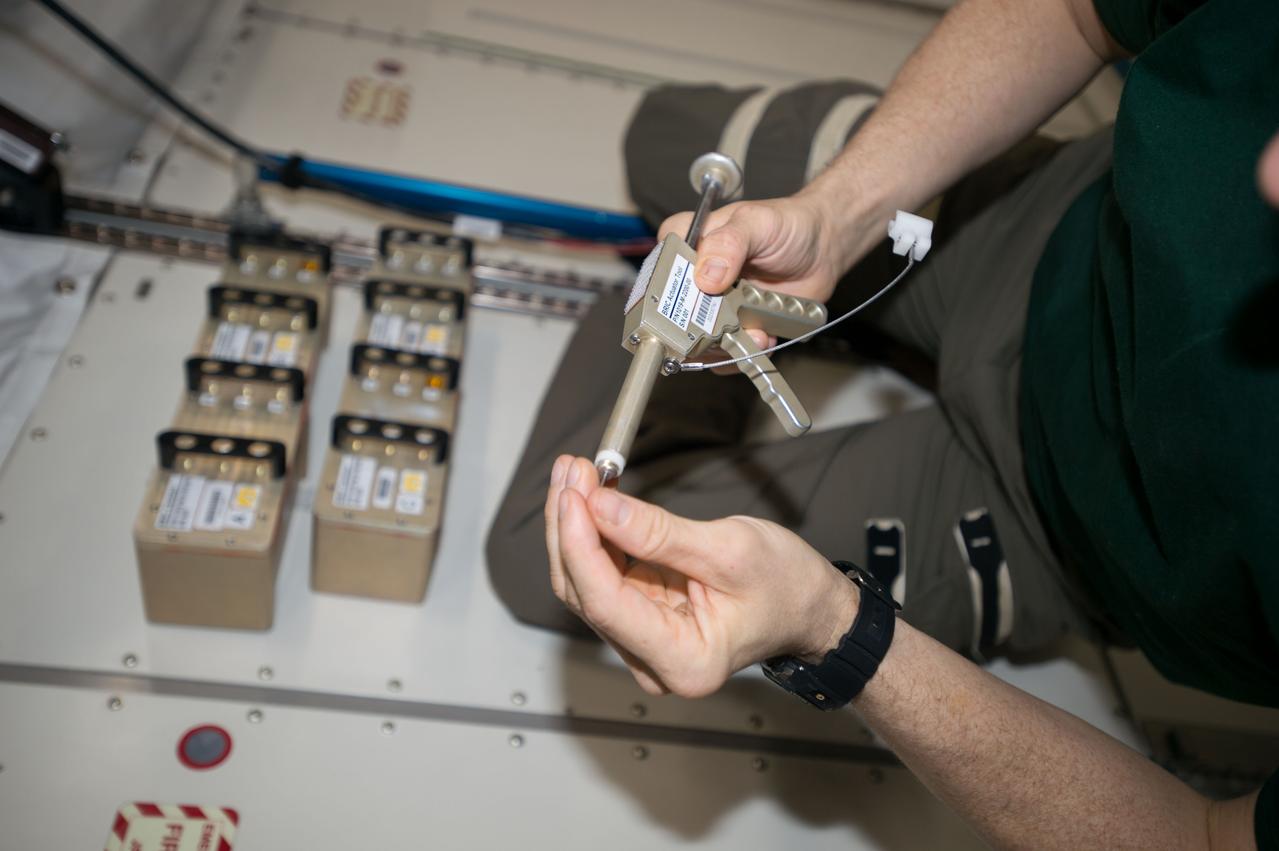 iss052e079043 (Aug. 31, 2017) --- NASA astronaut Jack Fischer actuating four cansiters of the Biological Research in Canisters-22 (BRIC-22) experiment in the Japanese Experiment Module (JEM) Pressurized Module (JPM). BRIC-22 studies the stress response in plants by comparing 8 different variants of thale cress (Arabidopsis thaliana) in the microgravity environment.