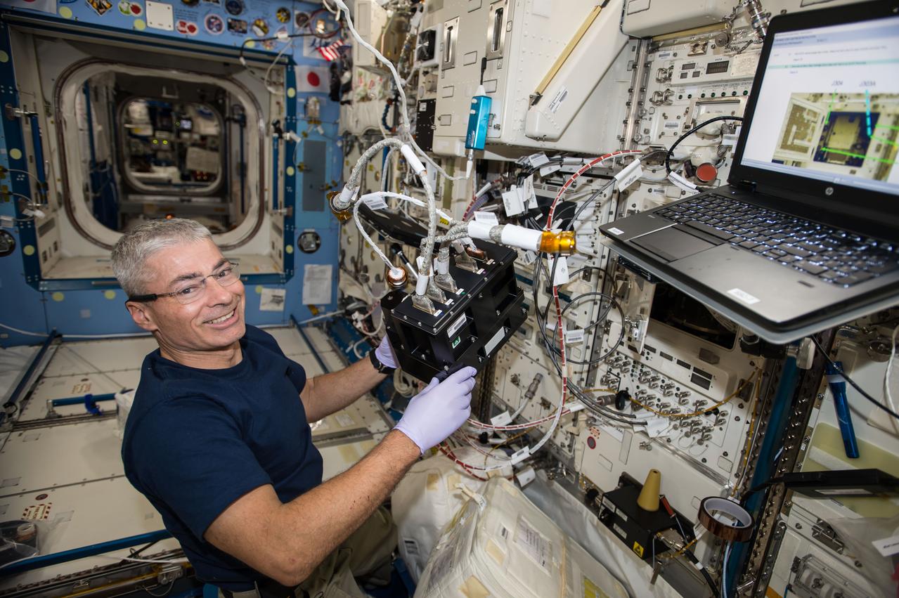iss053e039947 (9/22/2017) --- NASA astronaut Mark T. Vande Hei is shown with the Advanced Nano Step Cartridge in the Solution Crystallization Observation Facility (SCOF) during installation. The Effects of Impurities on Perfection of Protein Crystals, Partition Functions, and Growth Mechanisms (Advanced Nano Step) experiment monitors and records how the incorporation of specific impurity molecules affect the development and quality of protein crystals, as they grow in a quartz cell aboard the International Space Station (ISS).