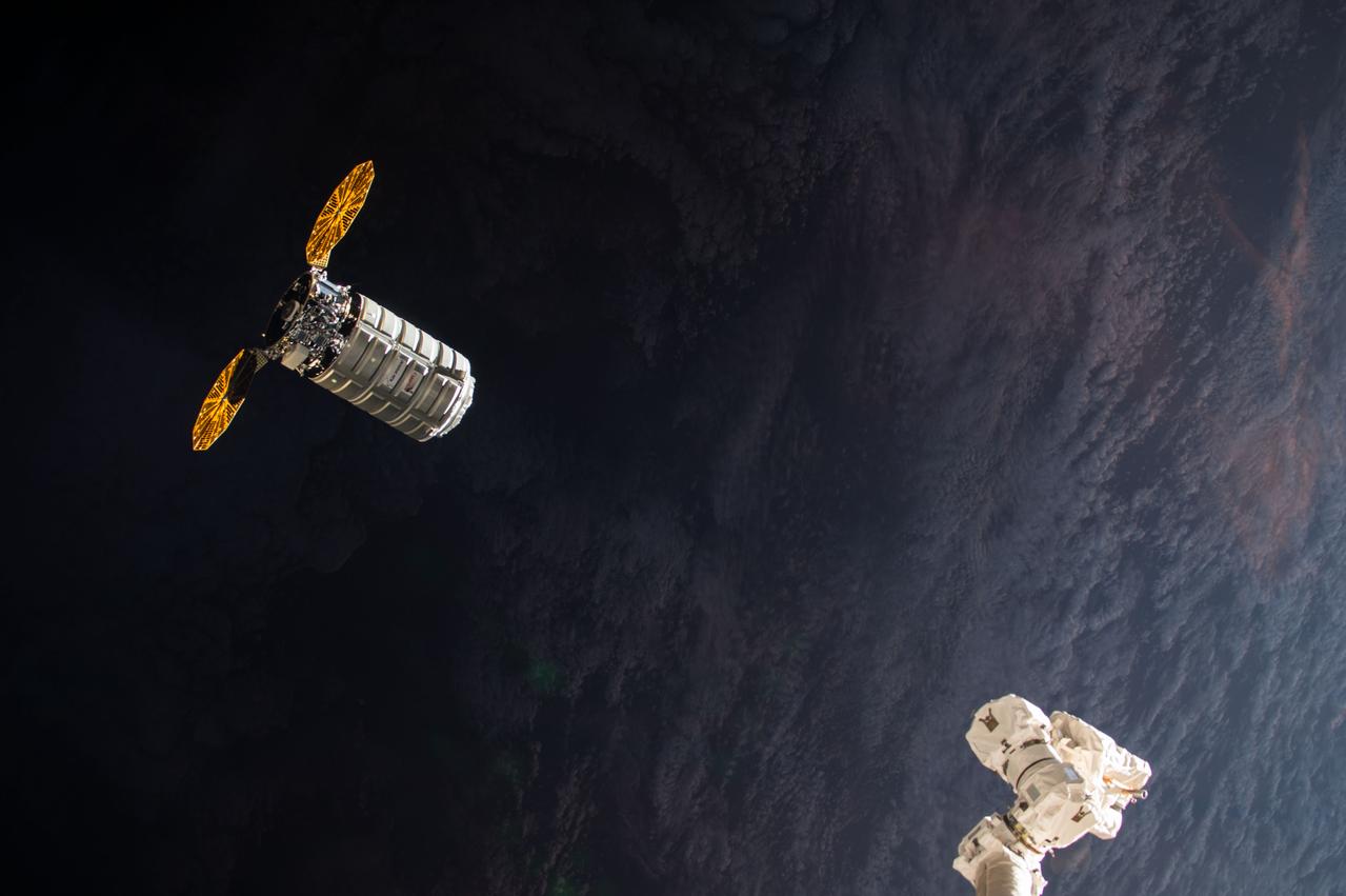 iss053e176252 (Nov. 14, 2017) --- The Orbital ATK Cygnus resupply ship with its cymbal-like UltraFlex solar arrays approaches the International Space Station's robotic arm, Canadarm2, as both spacecraft fly into an orbital sunrise.