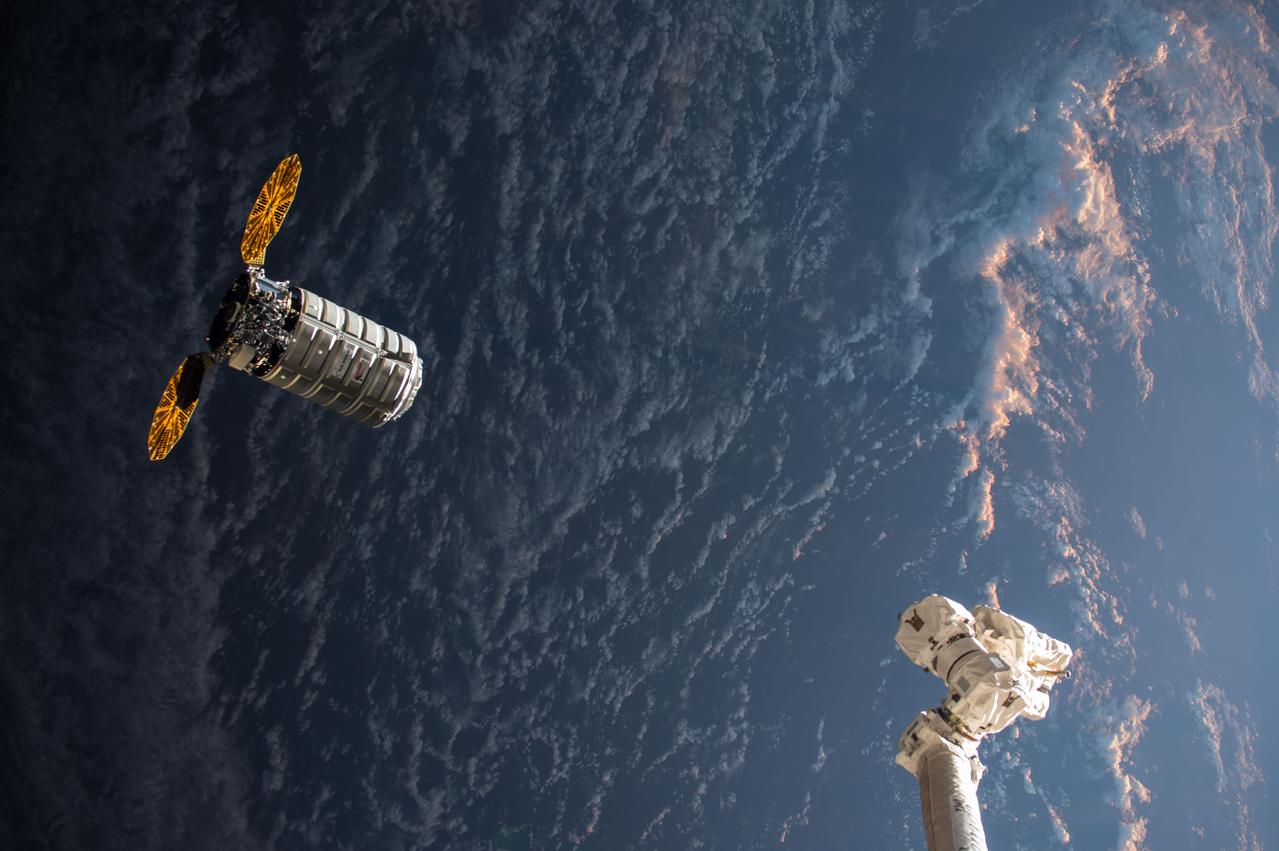 iss053e176255 (Nov. 14, 2017) ---  The Orbital ATK Cygnus resupply ship with its cymbal-like UltraFlex solar arrays approaches the International Space Station's robotic arm, Canadarm2, as both spacecraft fly into an orbital sunrise.