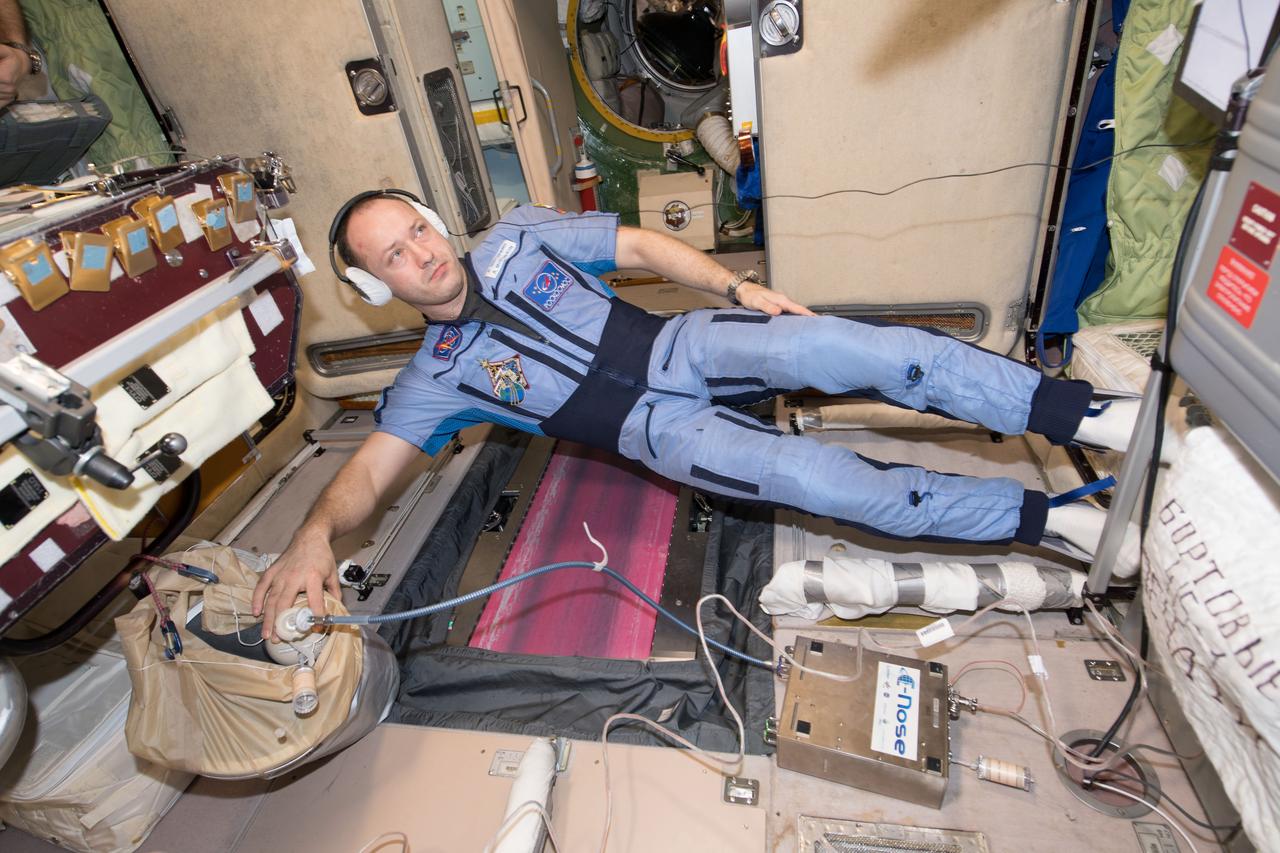 iss053e238931 (Nov. 22, 2017) --- Flight Engineer Alexander Misurkin from Roscosmos works with the JPL Electronic Nose (ENose) experiment in the Zvezda service module. ENose is a full-time, continuously operating event monitor designed to detect air contamination from spills and leaks in the crew habitat of the International Space Station. It fills the long-standing gap between onboard alarms and complex analytical instruments. ENose provides rapid, early identification and quantification of atmospheric changes caused by chemical species to which it has been trained. ENose can also be used to monitor cleanup processes after a leak or a spill.