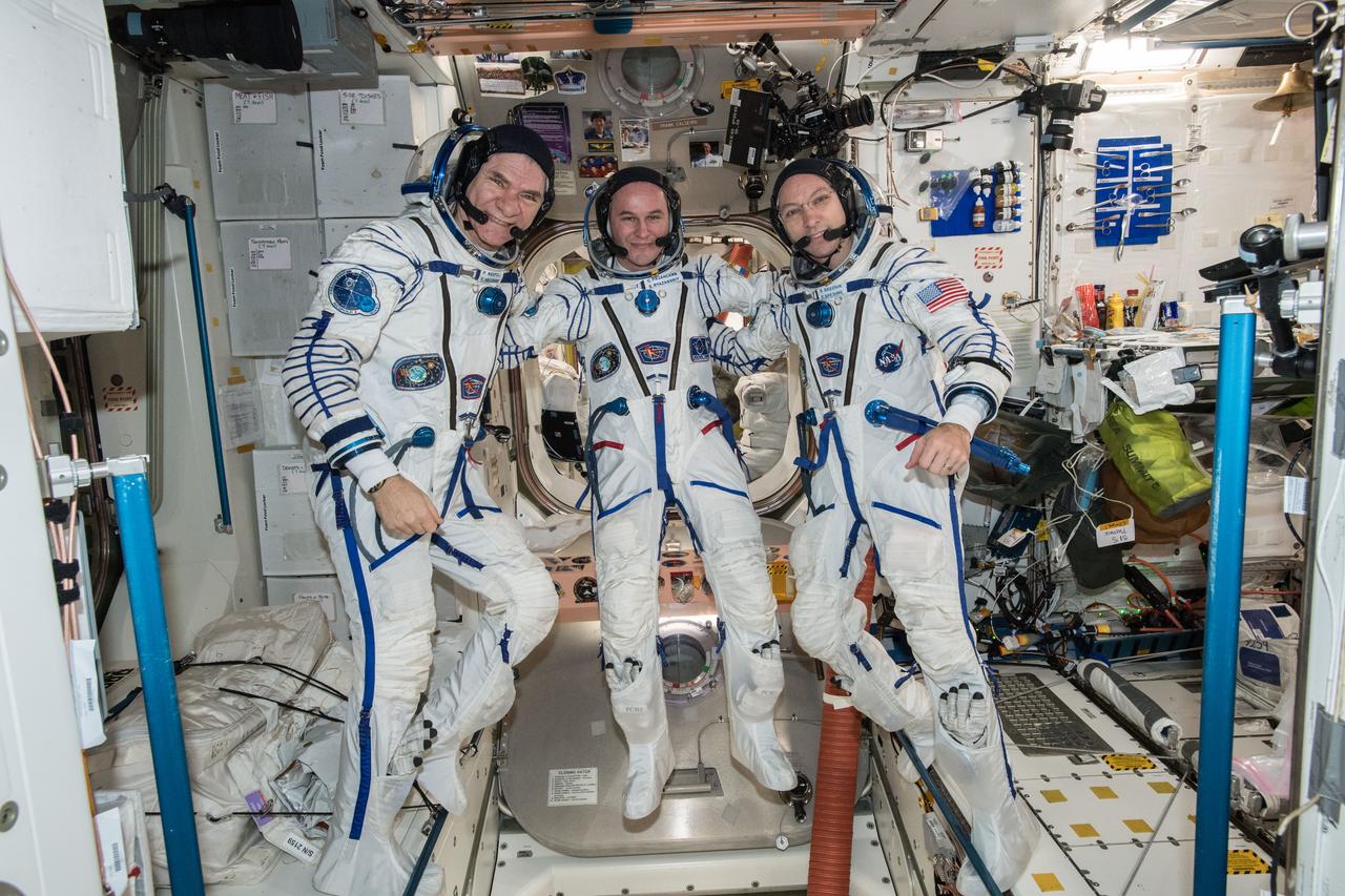 iss053e303563 (Dec. 4, 2017) --- Expedition 52-53 crew members (from left) Paolo Nespoli, Sergey Ryazanskiy and Randy Bresnik are pictured in their Sokol launch and entry suits as they prepare for their return to Earth after 139 days in space. The veteran space travelers were practicing the procedures they will use when they undock from the Rassvet module and parachute to a landing in Kazakhstan inside the Soyuz MS-05 spacecraft Dec.14.