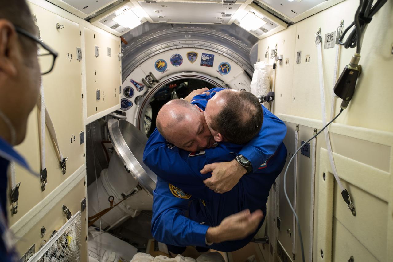 iss054e001407 (Dec. 19, 2017) --- International Space Station Commander Alexander Misurkin welcomes newly arrived Flight Engineer Scott Tingle in the Rassvet Mini-Research Module 1 following the hatch opening of the Soyuz MS-07 spacecraft.