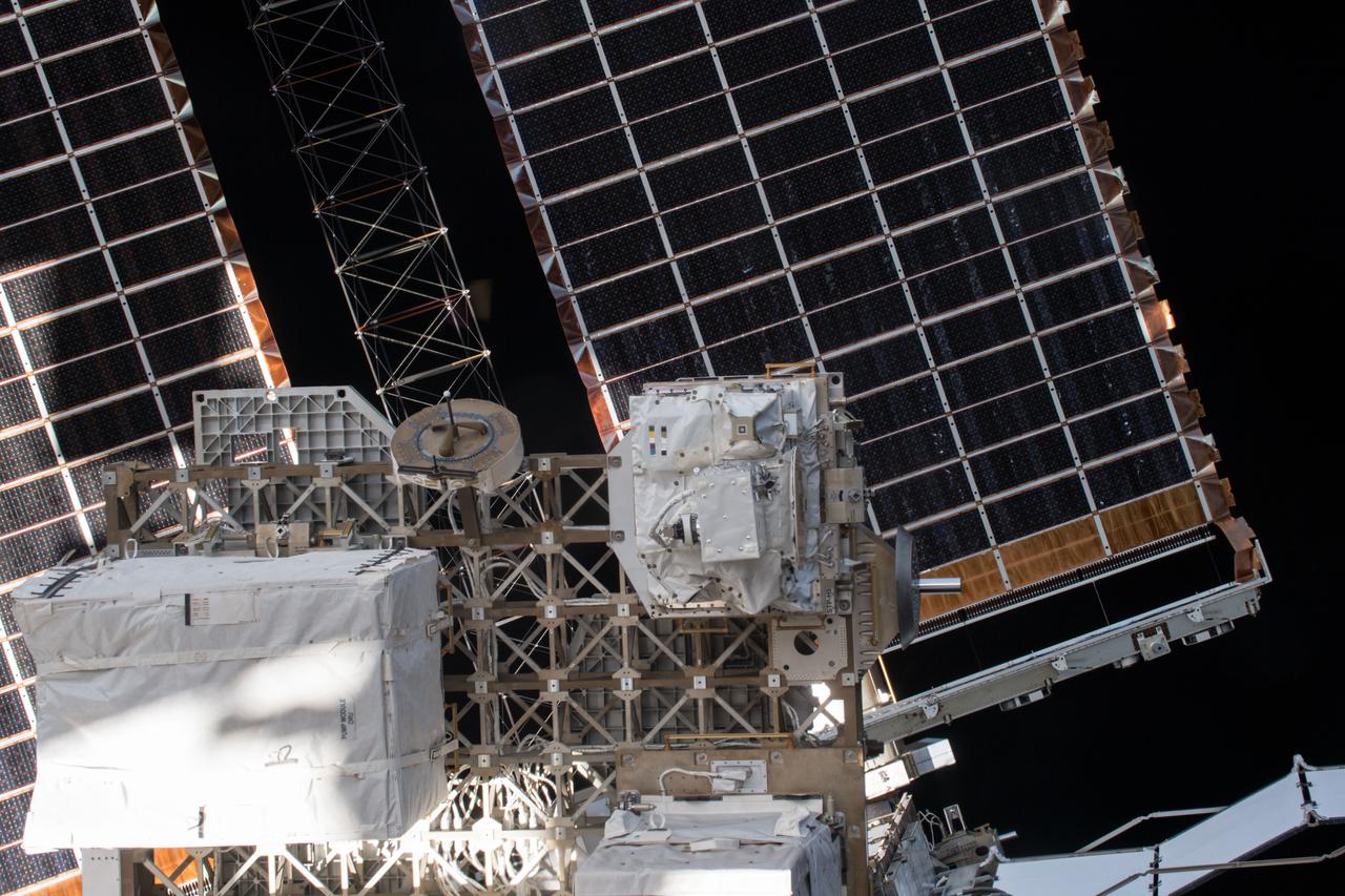 iss054e004101 (Dec. 26, 2017) --- Space Test Program - Houston 5 - Innovative Coatings Experiment (STP-H5-ICE) in front of International Space Station (ISS) solar panels. A spacecraft’s exterior coating protects against extreme temperatures, shields the spacecraft from radiation, prevents contamination, and guides cameras that help robots or humans capture and service the spacecraft. STP-H5-ICE studies different paints and coatings that protect spacecraft exteriors.