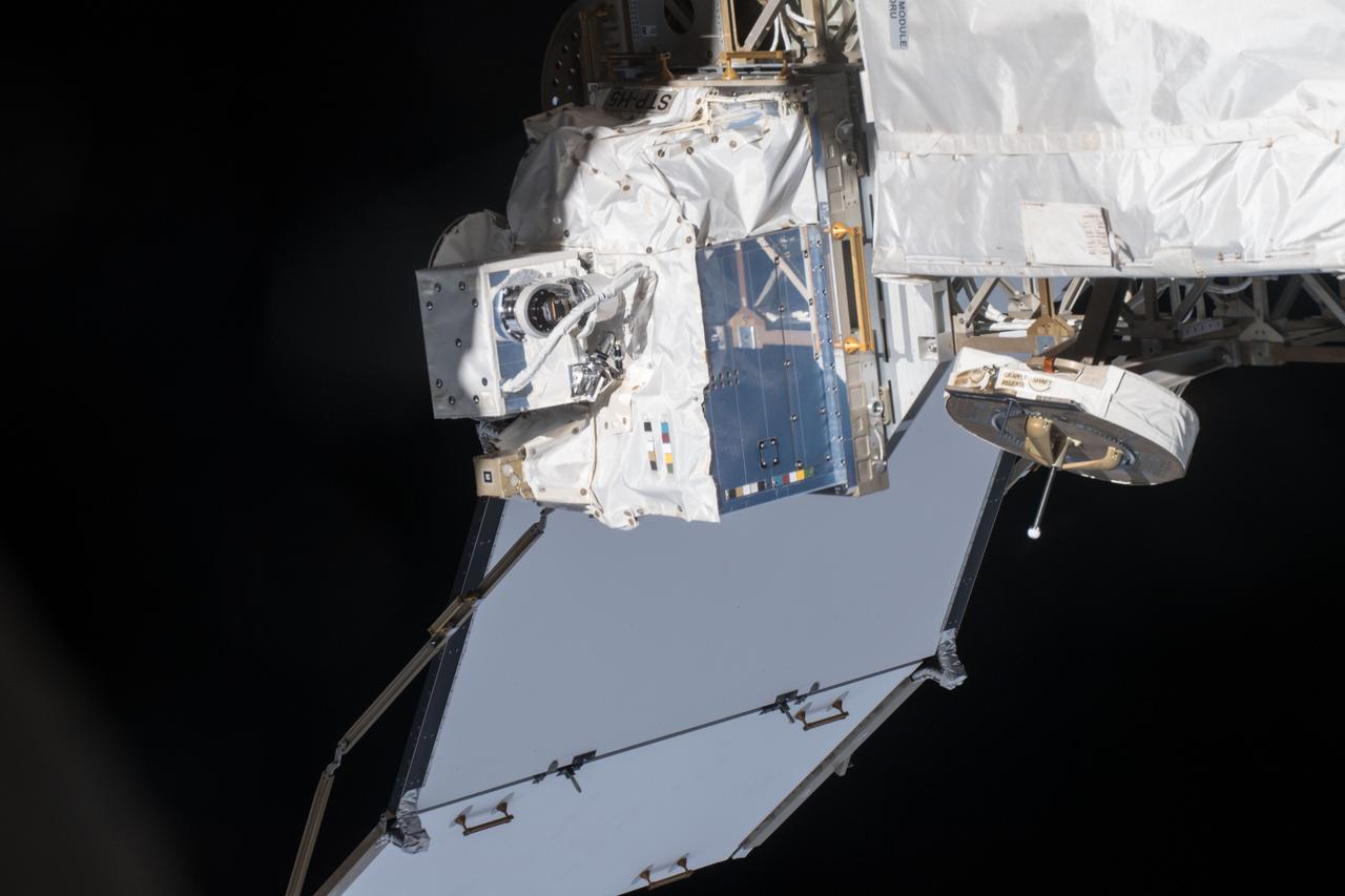 iss054e004116 (Dec. 26, 2017) --- Space Test Program - Houston 5 - Innovative Coatings Experiment (STP-H5-ICE) in front of International Space Station (ISS) radiator. A spacecraft’s exterior coating protects against extreme temperatures, shields the spacecraft from radiation, prevents contamination, and guides cameras that help robots or humans capture and service the spacecraft. STP-H5-ICE studies different paints and coatings that protect spacecraft exteriors.