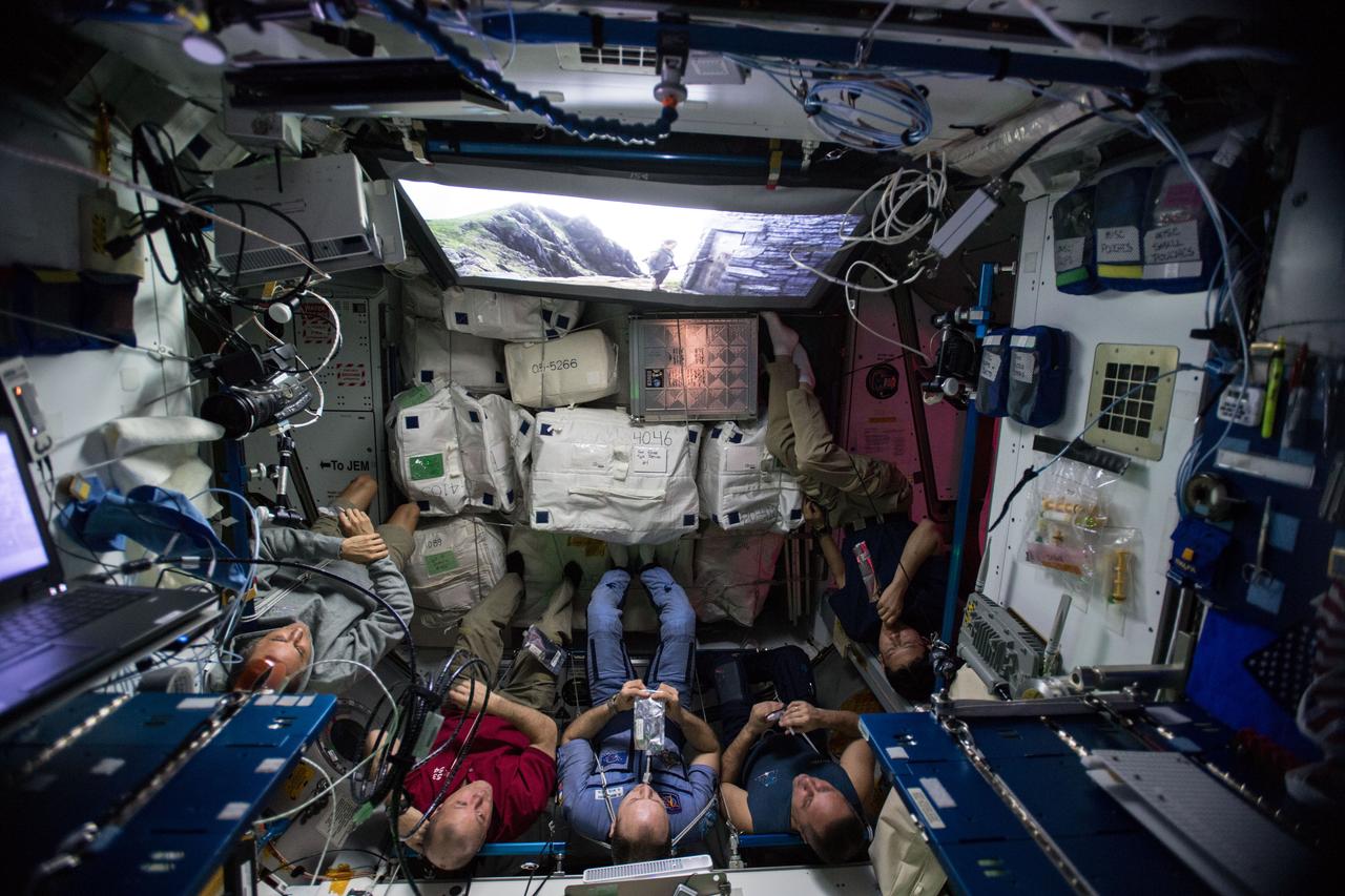 iss054e004241 (Dec. 23, 2017) --- The Expedition 54 crew aboard the International Space Station gathers in the Unity module for an out-of-this-world screening of the latest chapter of the Star Wars saga, The Last Jedi.