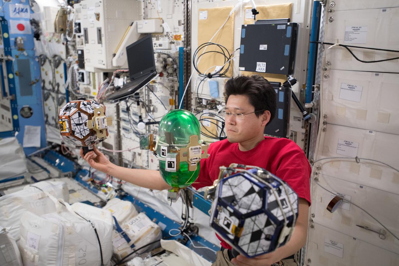 iss054e022175 (1/17/2018) --- Japan Aerospace Exploration Agency (JAXA) astronaut Norishige Kanai is photographed during a Synchronized Position Hold, Engage, Reorient, Experimental Satellites (SPHERES) Tether Slosh experiment test session run. Photo was taken in the Kibo Japanese Experiment Pressurized Module (JPM) aboard the International Space Station (ISS). SPHERES Tether Slosh combines fluid dynamics equipment with robotic capabilities aboard the ISS to investigate automated strategies for steering passive cargo that contain fluids. In space, the fluid fuels used by spacecraft can slosh around in unpredictable ways making space maneuvers difficult. SPHERES Tether Slosh uses two Synchronized Position Hold, Engage, Reorient, Experimental Satellites (SPHERES) robots tethered to a fluid-filled container covered in sensors to test strategies for safely steering spacecraft such as dead satellites that might still have fuel in the tank.