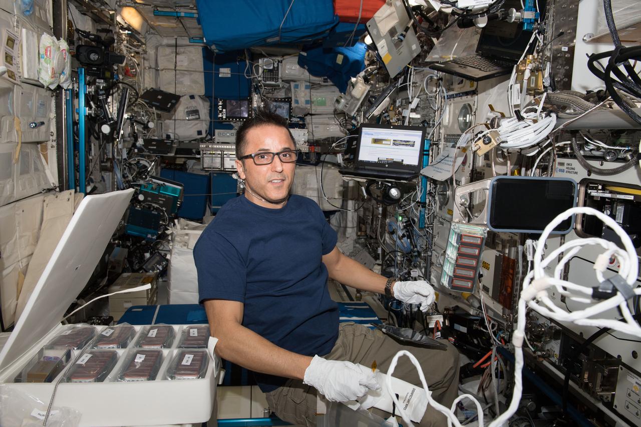 iss054e023797 (Jan. 26, 2018) --- NASA astronaut Joe Acaba with an Experiment Container (EC) to begin the Plant Gravity Perception experiment, testing the gravity-sensing ability of plants in microgravity.