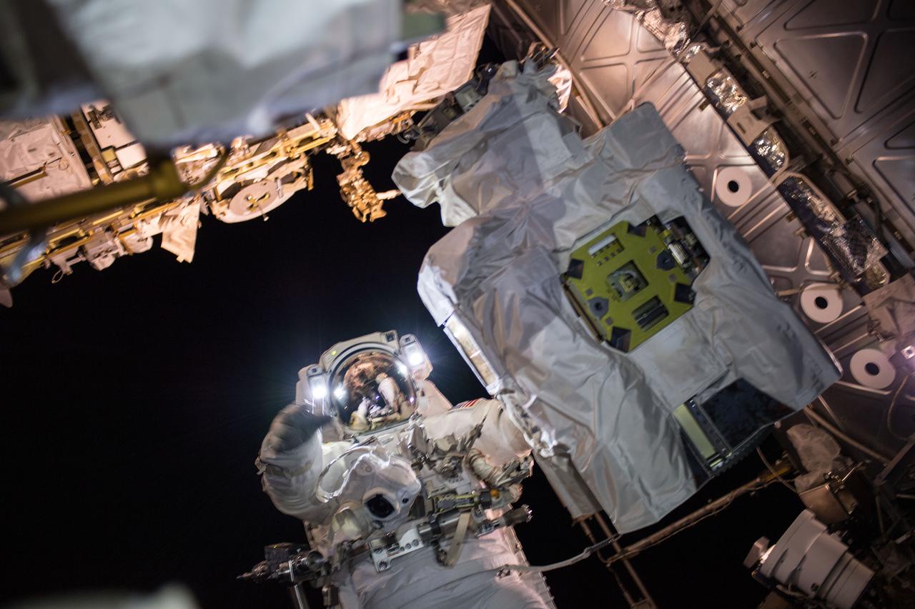 iss054e047933 (Feb. 16, 2018) --- NASA astronaut and Expedition 53 Flight Engineer Mark Vande Hei is pictured servicing components on the Canadarm2 robotic arm during a spacewalk with astronaut Norishige Kanai (out of frame) of the Japan Aerospace Exploration Agency (JAXA).