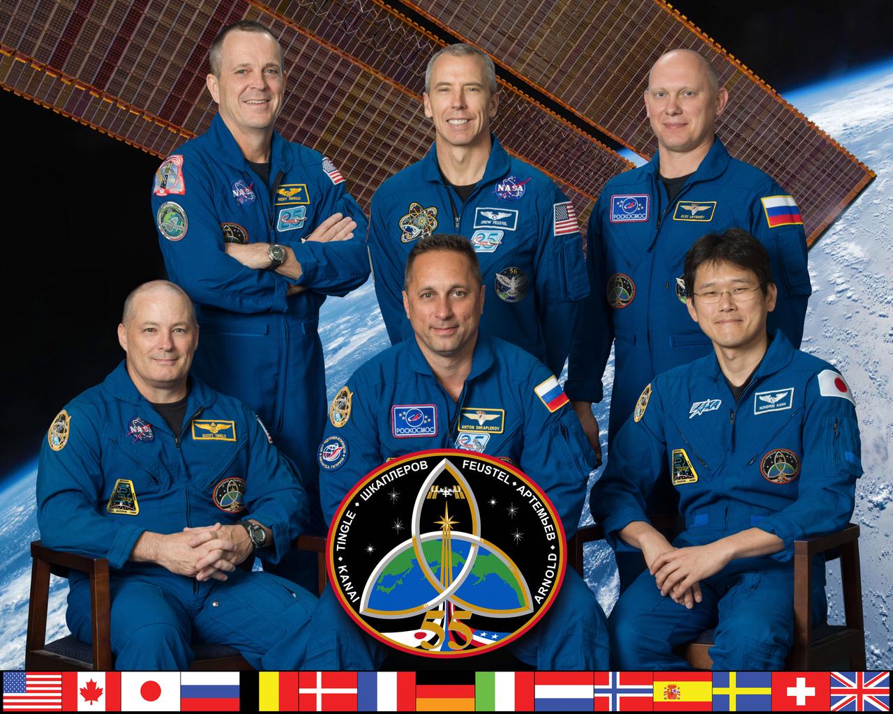 iss055-s-002 (Oct. 6, 2017) --- The six-member Expedition 55 crew poses for an official crew portrait at the Johnson Space Center in Houston, Texas. In the front row (from left) are Scott Tingle of NASA, Commander Anton Shkaplerov of Roscosmos and Norishige Kanai of the Japan Aerospace Exploration Agency. In the back row (from left) are NASA astronauts Ricky Arnold and Andrew Feustel and Roscosmos cosmonaut Oleg Artemyev.