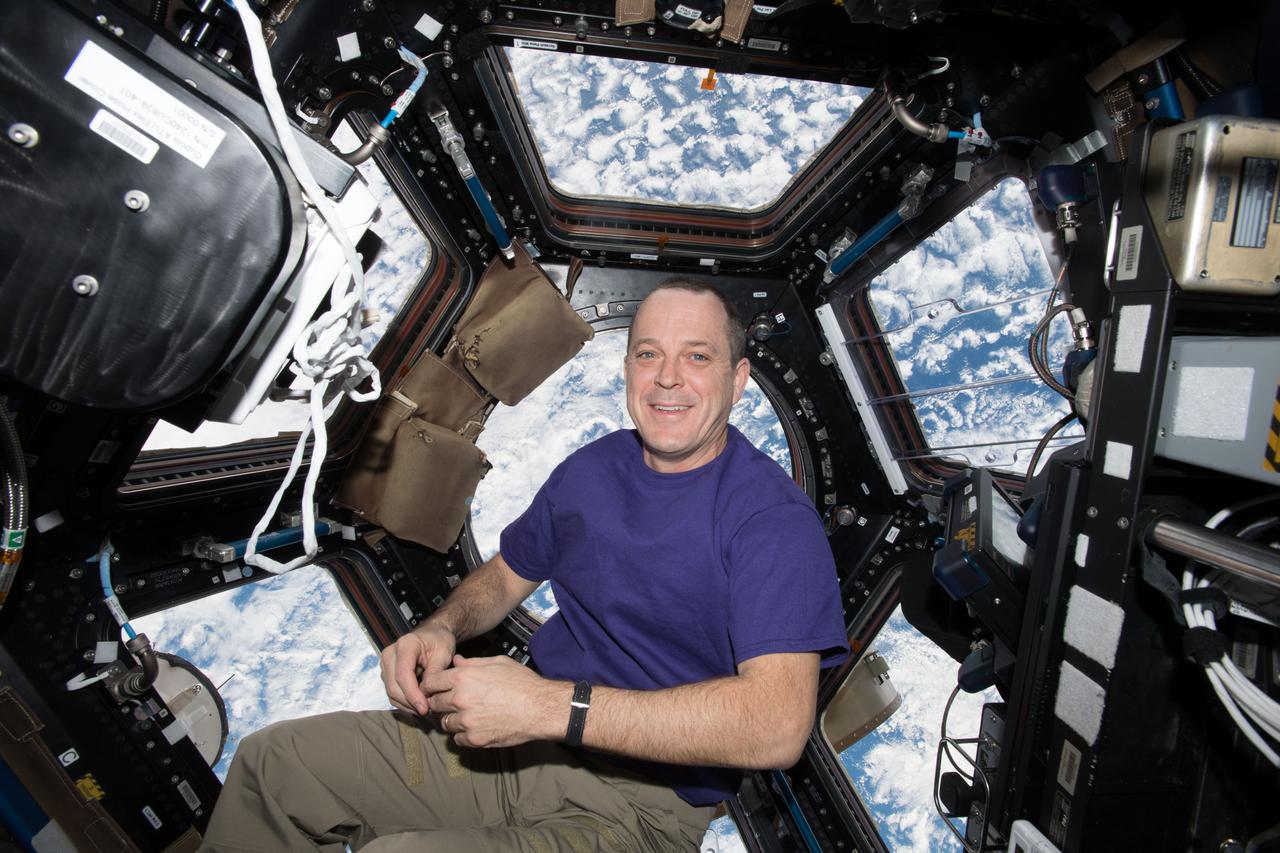 iss055e004444 (March 24, 2018) --- NASA astronaut and Expedition 55 Flight Engineer Ricky Arnold rests inside the seven-windowed cupola as the International Space Station orbits above the south Atlantic Ocean.