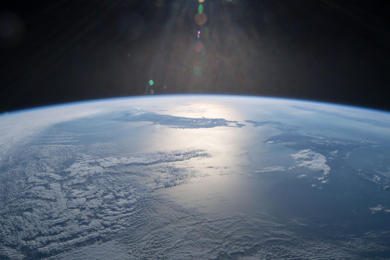 iss055e006531 (March 30, 2018) --- The International Space Station was off the coast of northern Japan when an Expedition 55 crew member took this photograph. The sun's glint is reflected off the Sea of Japan and the North Pacific Ocean.