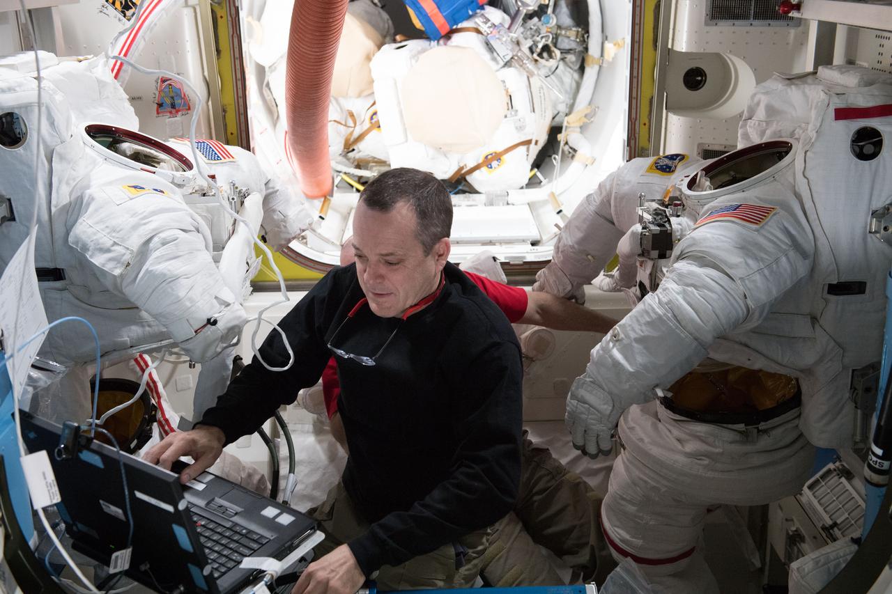 iss055e008293 (April 2, 2018) --- Astronaut Ricky Arnold completes the scrubbing of water cooling loops inside a pair of U.S. spacesuits after the completion of spacewalk on March 29, 2018.