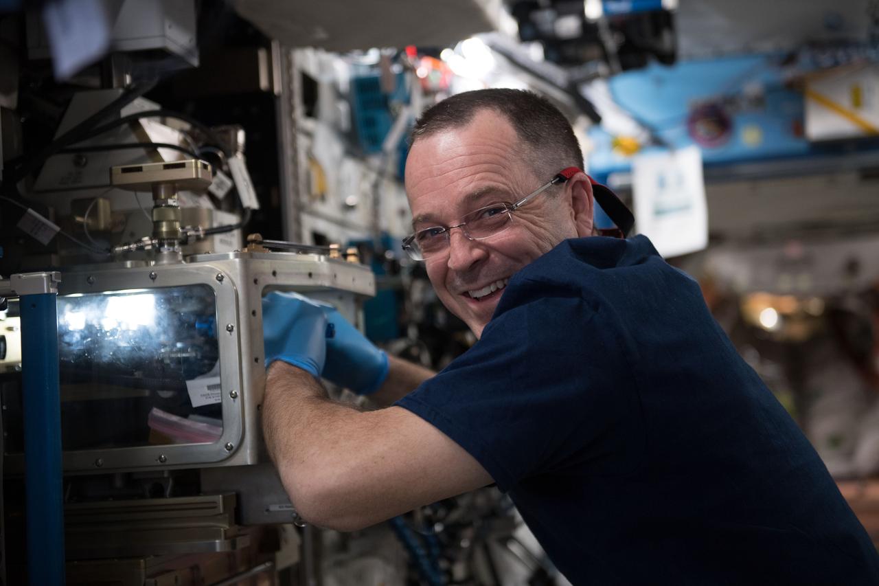 iss055e035366 (April 16, 2018) --- NASA astronaut Ricky Arnold performs maintenance on the Advanced Colloids Experiment Module located inside the Light Microscopy Module which is a modified commercial, highly flexible, state-of-the-art light imaging microscope facility that provides researchers with powerful diagnostic hardware and software in microgravity.