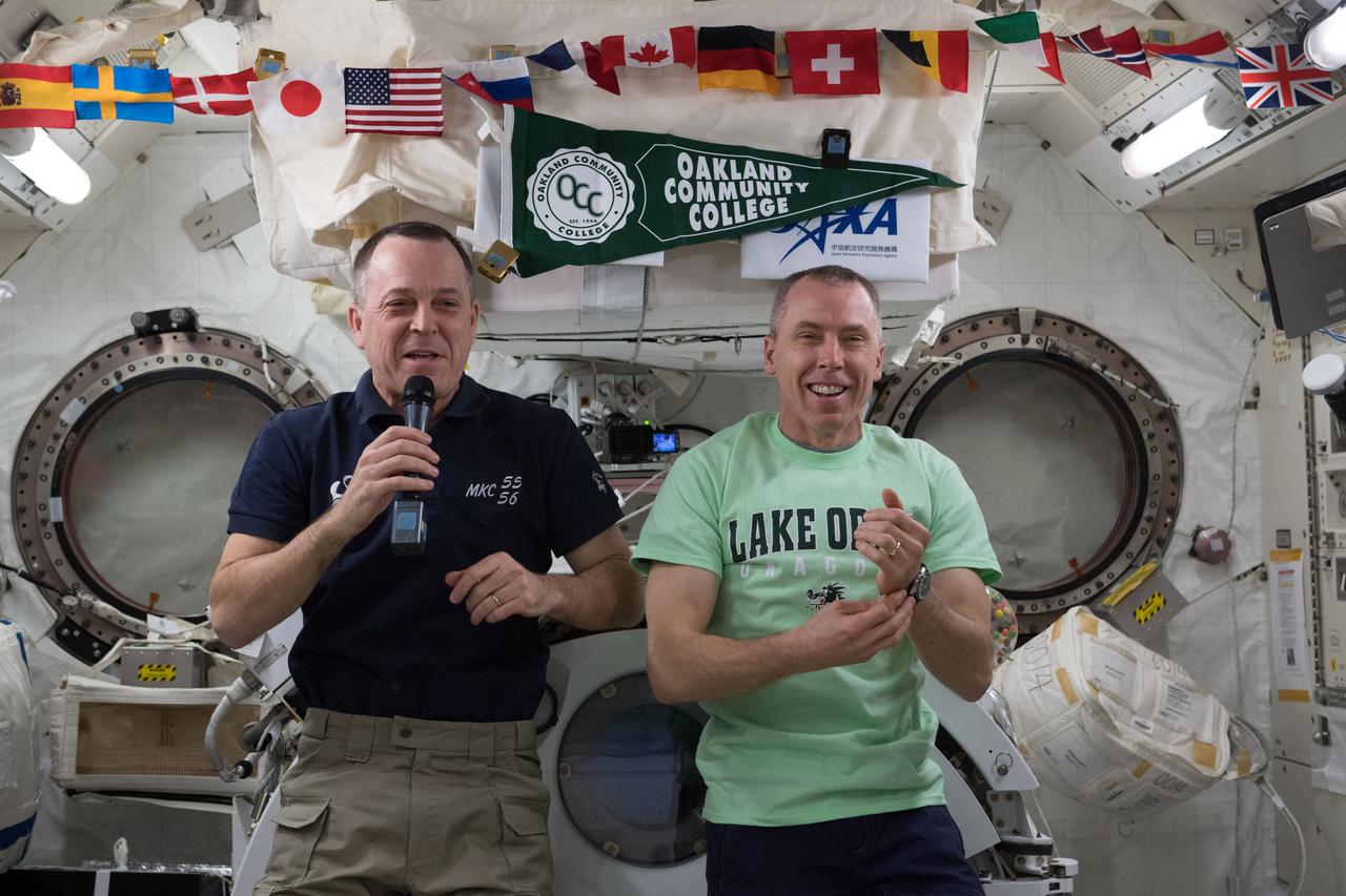 iss055e035373 (April 17, 2018) --- NASA astronauts Ricky Arnold (left) and Drew Feustel are pictured inside the Japanese Kibo laboratory module talking to high school and college students from Lake Orion, Mich.