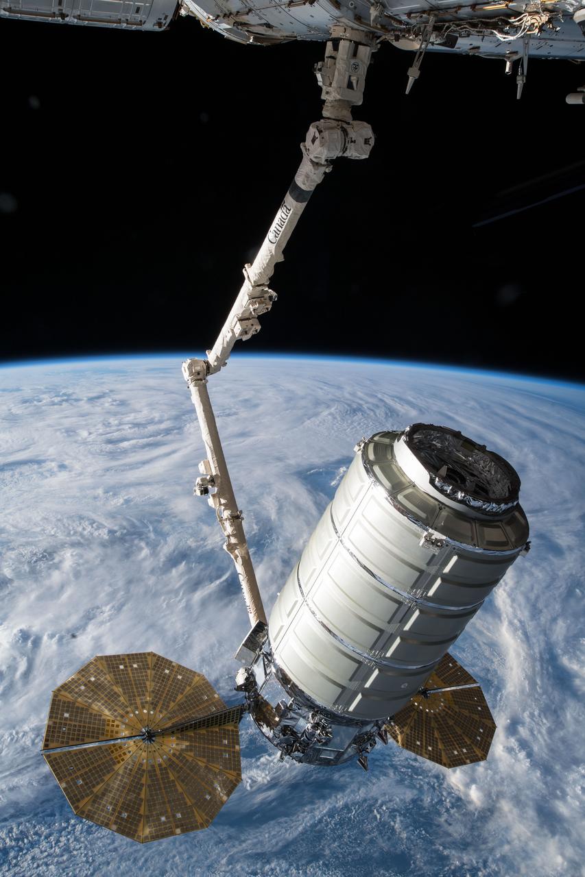 iss055e076762 (May 24, 2018) --- The Orbital ATK space freighter is slowly maneuvered by the Canadarm2 robotic arm toward the Unity module for installation on the International Space Station to resupply the Expedition 55 crew.
