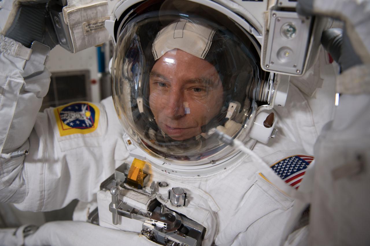 iss055e108824 (May 7, 2018) --- NASA astronaut Drew Feustel is suited up inside his U.S. spacesuit for a fit check verification ahead of a spacewalk that took place May 16, 2016.