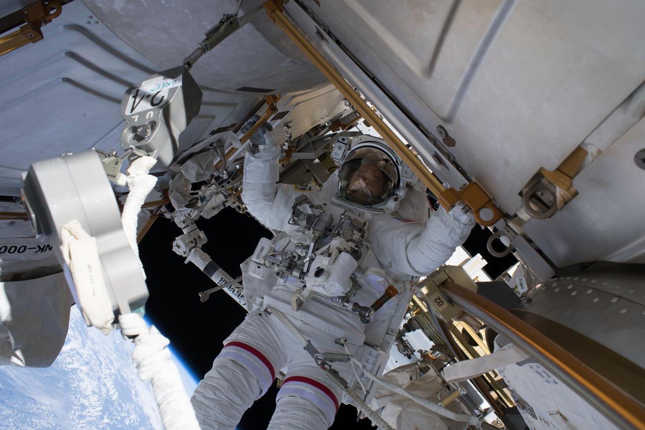 iss056e012052 (June 14, 2018) --- NASA astronaut Ricky Arnold is pictured during a spacewalk he conducted with fellow NASA astronaut Drew Feustel (out of frame) on June 14, 2018. During the six-hour, 49-minute spacewalk the duo installed high-definition cameras to provide enhanced views of commercial crew spacecraft, including the SpaceX Crew Dragon and the Boeing Starliner, as they approach and dock with the International Space Station.