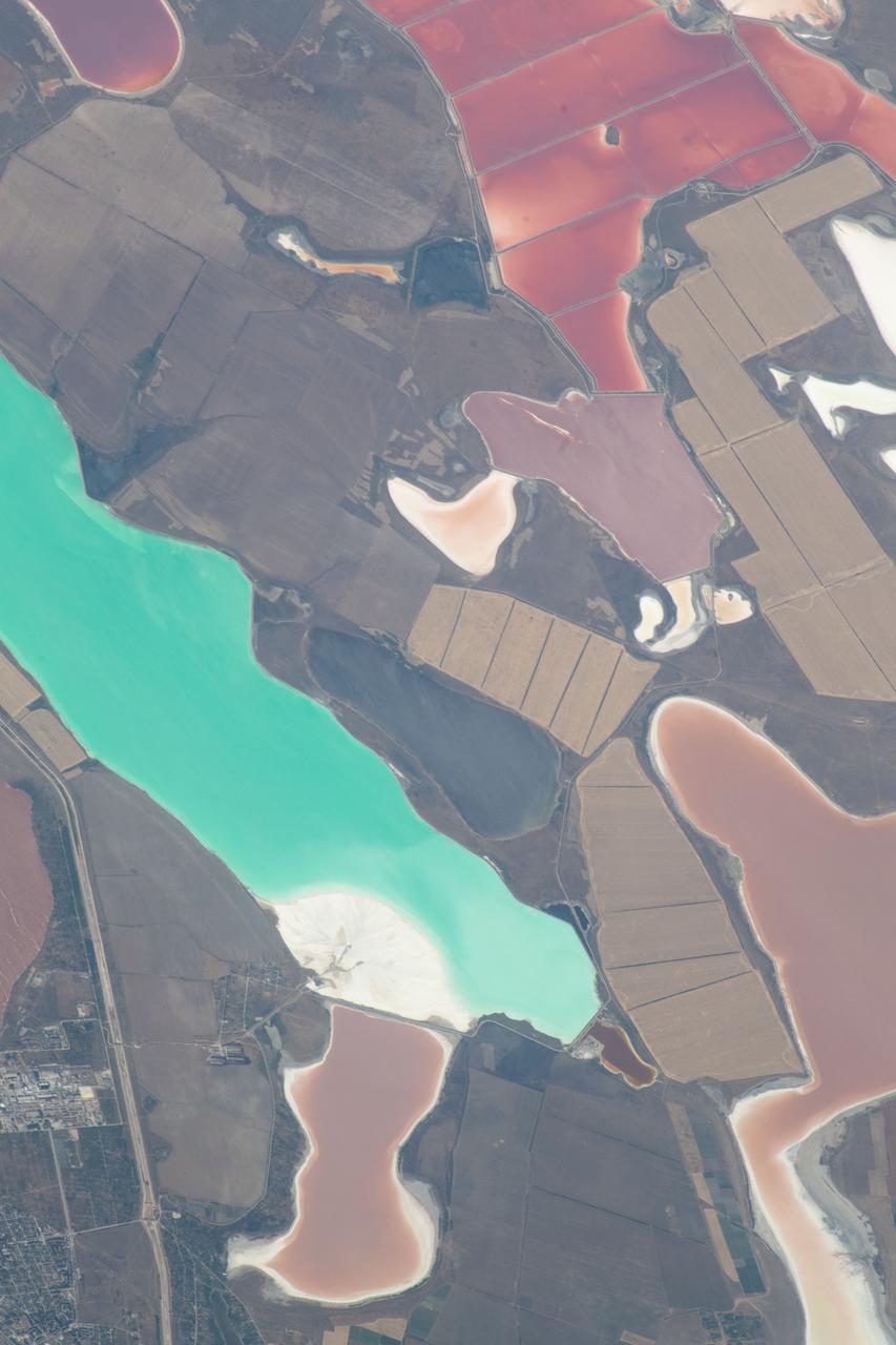 iss056e032828 (June 24, 2018) --- An Expedition 56 crew member aboard the International Space Station pictured lagoons in the Crimea between the Sea of Azov and the Black Sea which appear different colors due to shallow waters and their varied chemical composition.