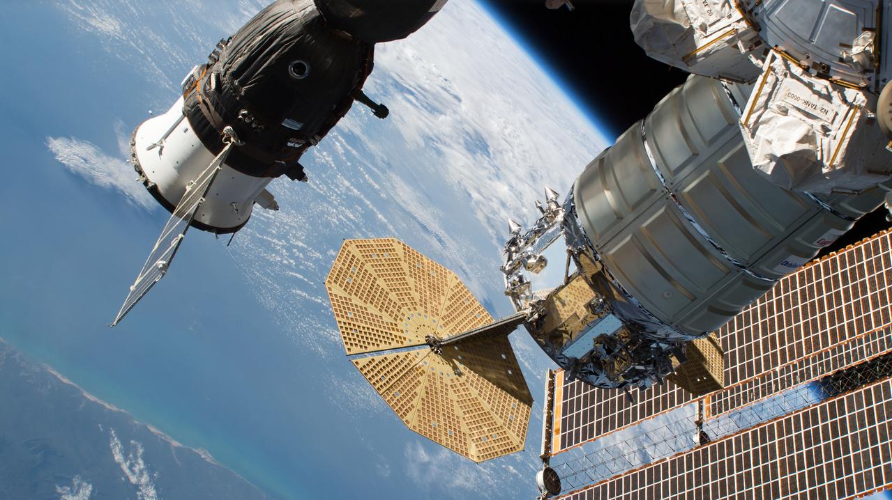 iss056e032835 (June 24, 2018) --- The Russian Soyuz MS-09 crew craft and the Northrop Grumman (formerly Orbital ATK) Cygnus space freighter are seen attached to the International Space Station with the orbital complex's basketball court-sized solar arrays in the lower right background. The eastern coast of Brazil is pictured in the lower left corner of the frame.
