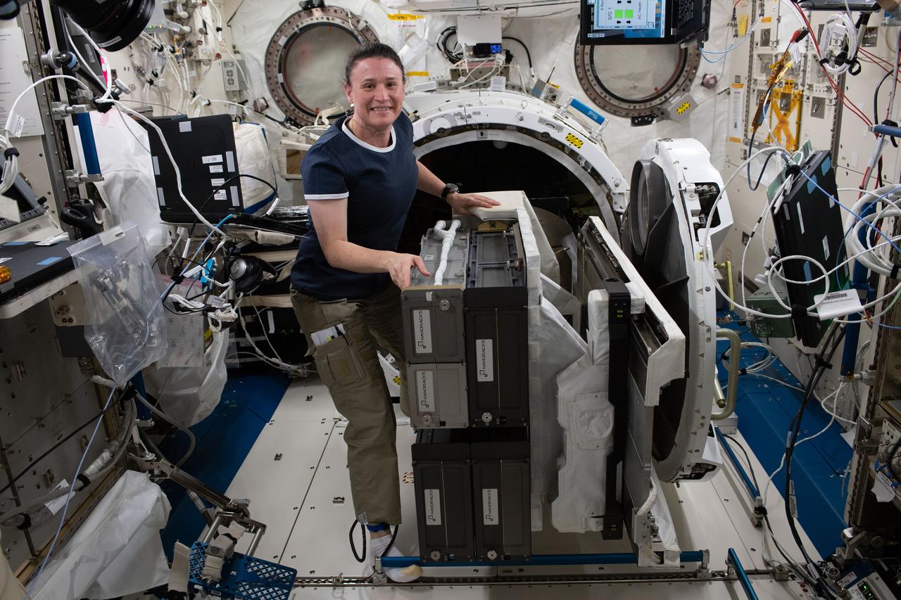 iss056e033124 (June 25, 2018) --- Expedition 56 Flight Engineer Serena Auñón-Chancellor installs the NanoRacks Cubesat Deployer-14 (NRCSD-14) on the Multipurpose Experiment Platform inside the Japanese Kibo laboratory module. The NRCSD-14 was then placed in the Kibo airlock and moved outside of the space station to deploy a variety of cubesats into Earth orbit.