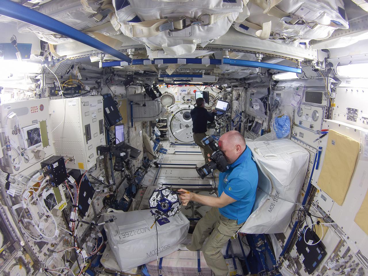 iss056e050304 (6/28/2018) --- Cosmonaut Oleg Artemyev and NASA astronaut Ricky Arnold during the Synchronized Position Hold Engage and Reorient Experimental Satellites (SPHERES) maintenance session two, in the Japanese Experiment Module (JEM) Pressurized Module (JPM).