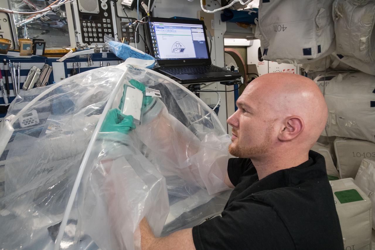 iss056e073250 (July 2, 2018) --- Astronaut Alexander Gerst of ESA (European Space Agency) works on the Microgravity Investigation of Cement Solidification (MICS) 2 experiment aboard the International Space Station. MICS 2 is researching how cement reacts in space during the hardening process and may help engineers better understand its microstructure and material properties. Observations could improve cement processing techniques on Earth and lead to the design of safer, lightweight space habitats.