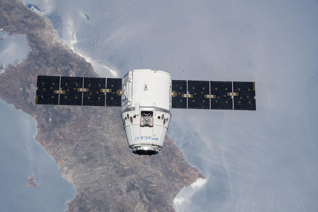 iss056e073506 (July 2, 2018) --- The SpaceX Dragon cargo craft is pictured approaching the International Space Station as both spacecraft were orbiting over the Greek island of Crete.