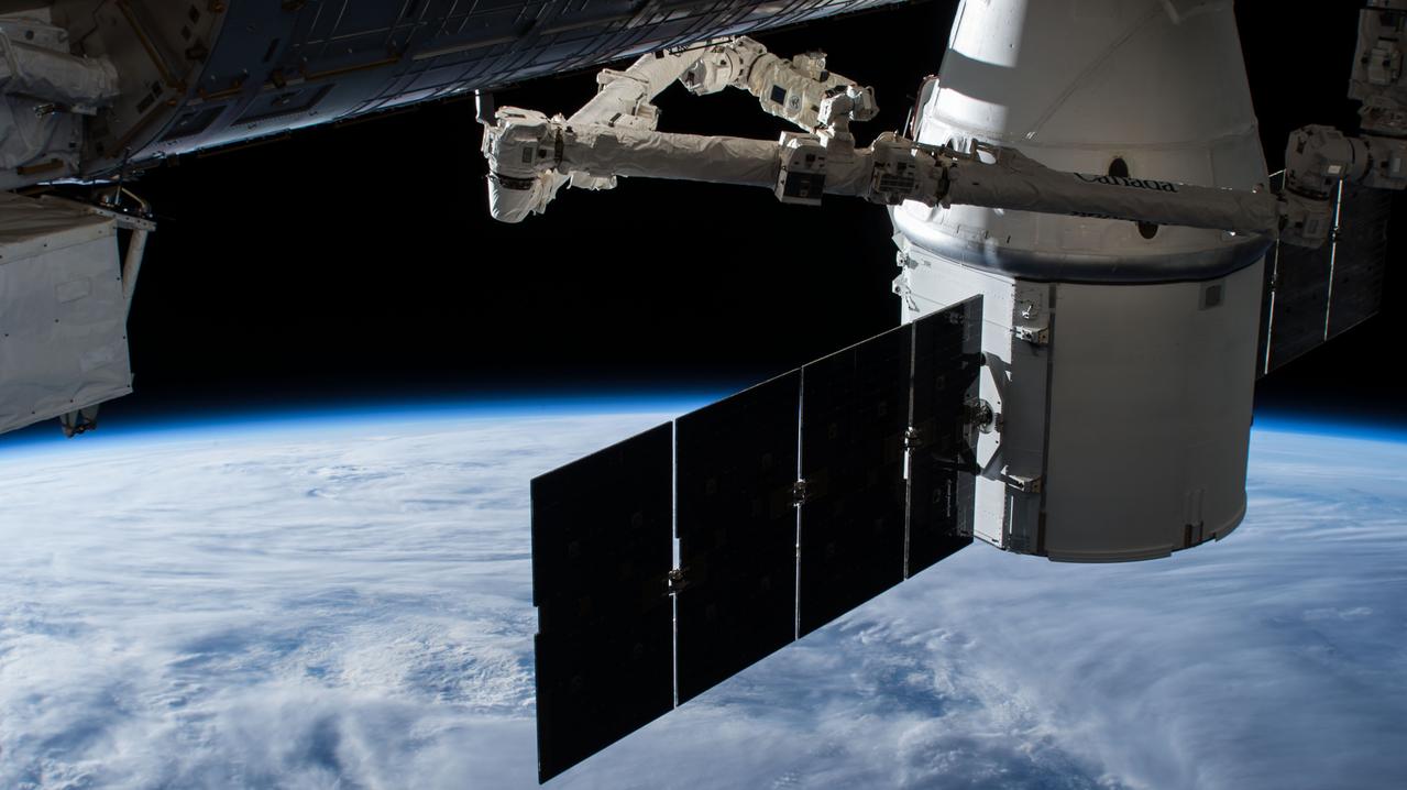 iss056e075963 (July 3, 2018) --- The SpaceX Dragon resupply ship is pictured attached to the International Space Station's Harmony module the day after it was captured by NASA astronaut Ricky Arnold operating the Canadarm2 robotic arm.