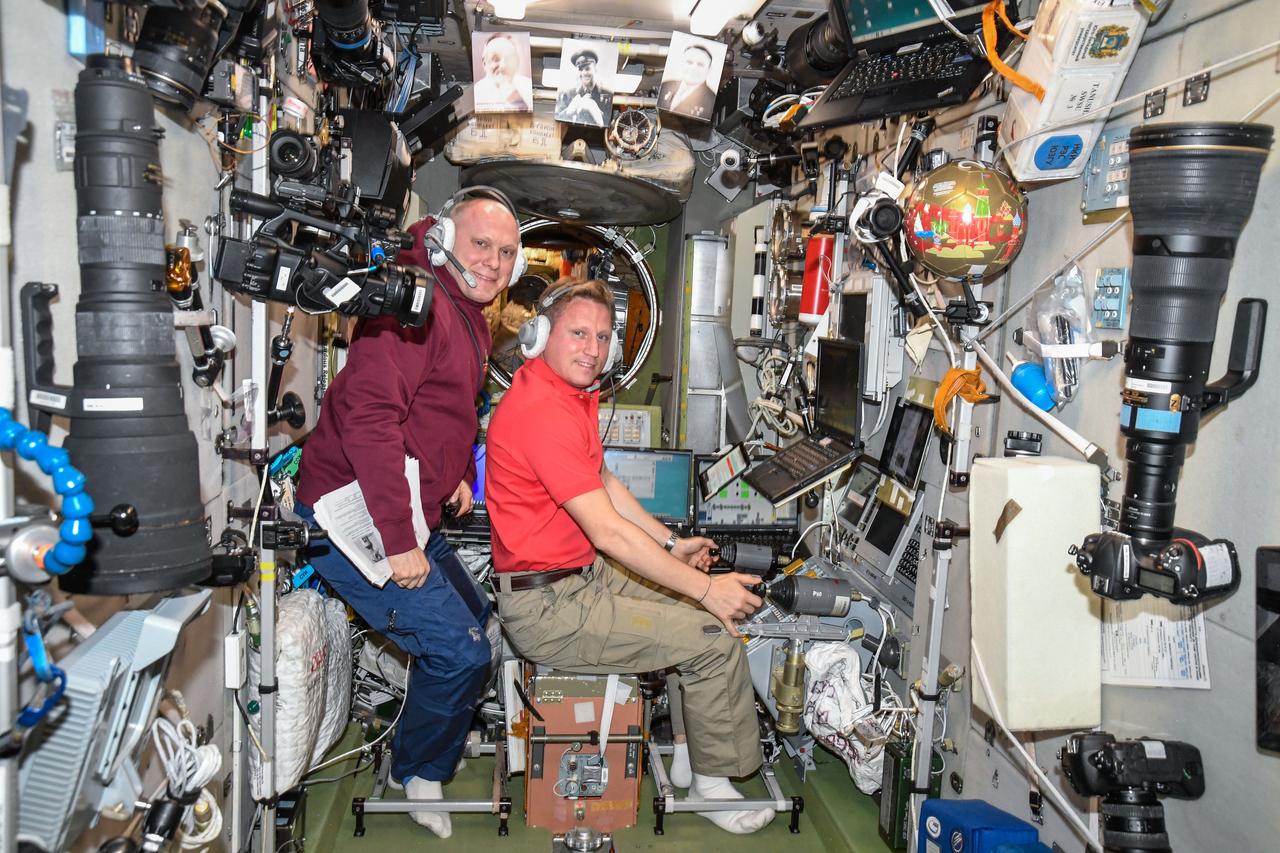 iss056e081639 (July 6, 2018) --- Cosmonauts Oleg Artemyev and Sergey Prokopyev practice using the TORU, or telerobotically-operated rendezvous system, inside the Zvezda service module which is part if the International Space Station's Russian segment. If necessary a crew member could use the TORU to manually dock an approaching Russian Progress cargo craft at the space station in case of an emergency. Credit: Roscosmos