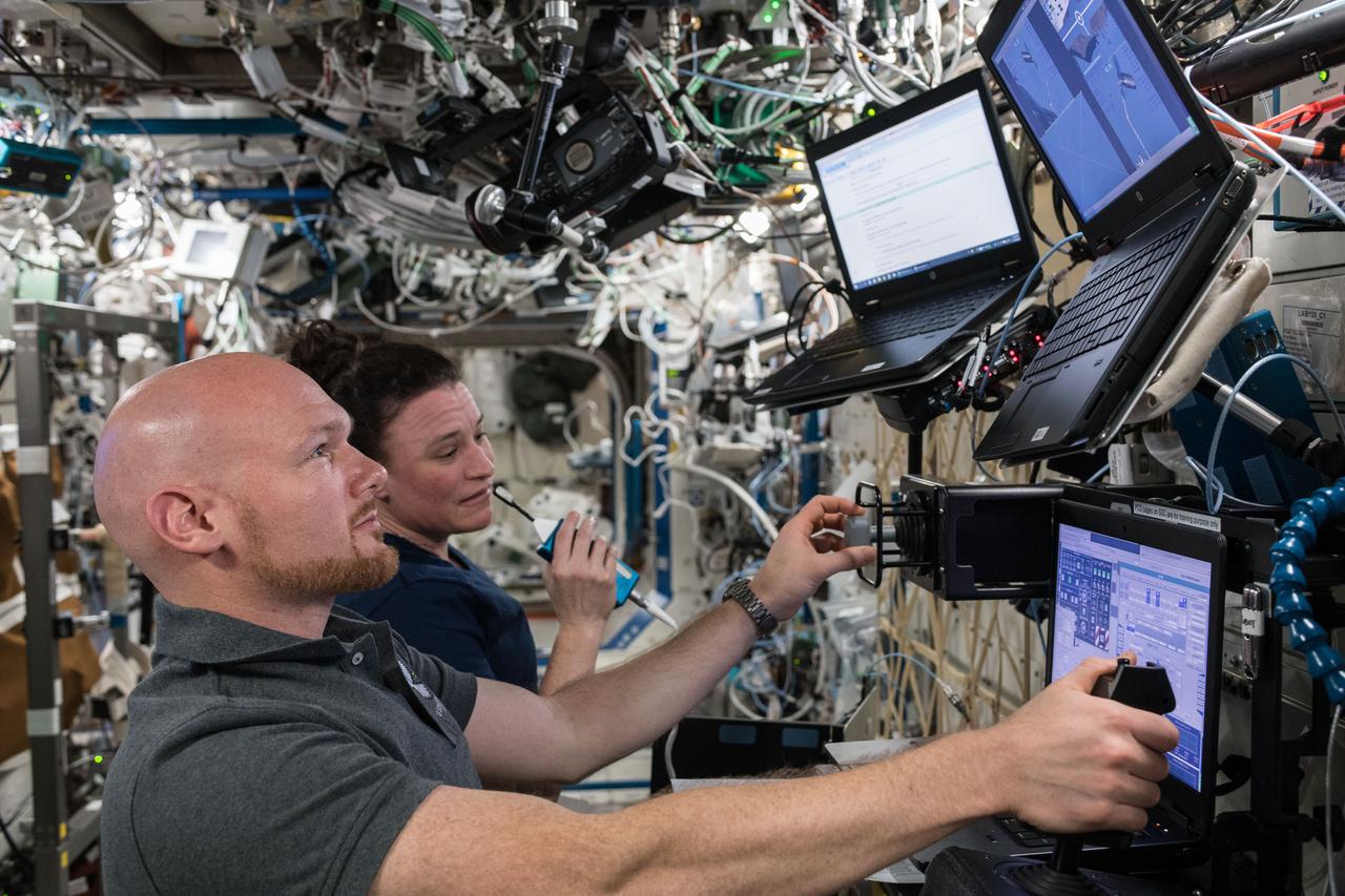 iss056e095057 (July 13, 2018) --- Astronauts Alexander Gerst and Serena Auñón-Chancellor train on computers for the release of the Northrop Grumman (formerly Orbital ATK) Cygnus space freighter. The duo would command the Canadarm2 robotic arm to release Cygnus back into Earth orbit on July 15 after 52 days of cargo transfers at the International Space Station.