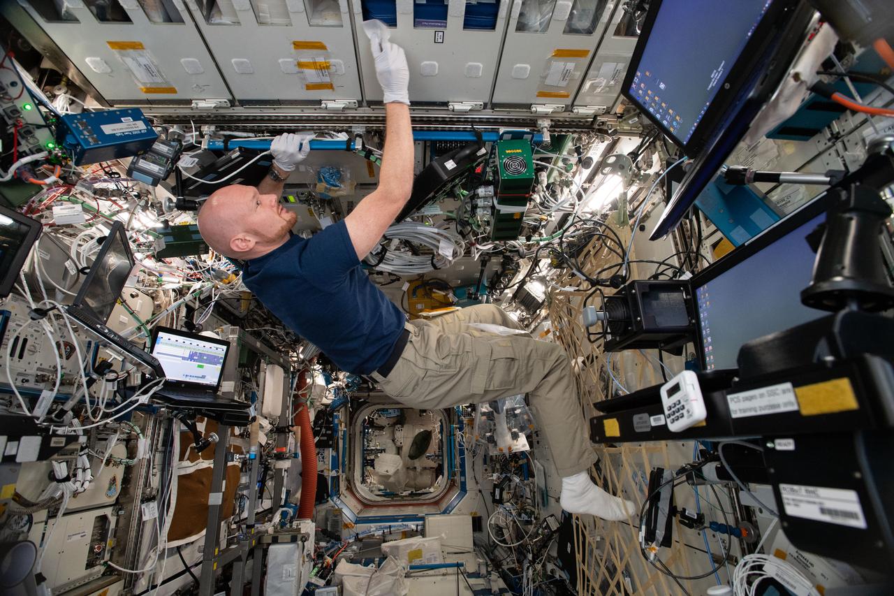 iss056e099195 (July 28, 2018) --- German astronaut Alexander Gerst of ESA (European Space Agency) is busy with housecleaning activities inside the International Space Station's Destiny laboratory module.