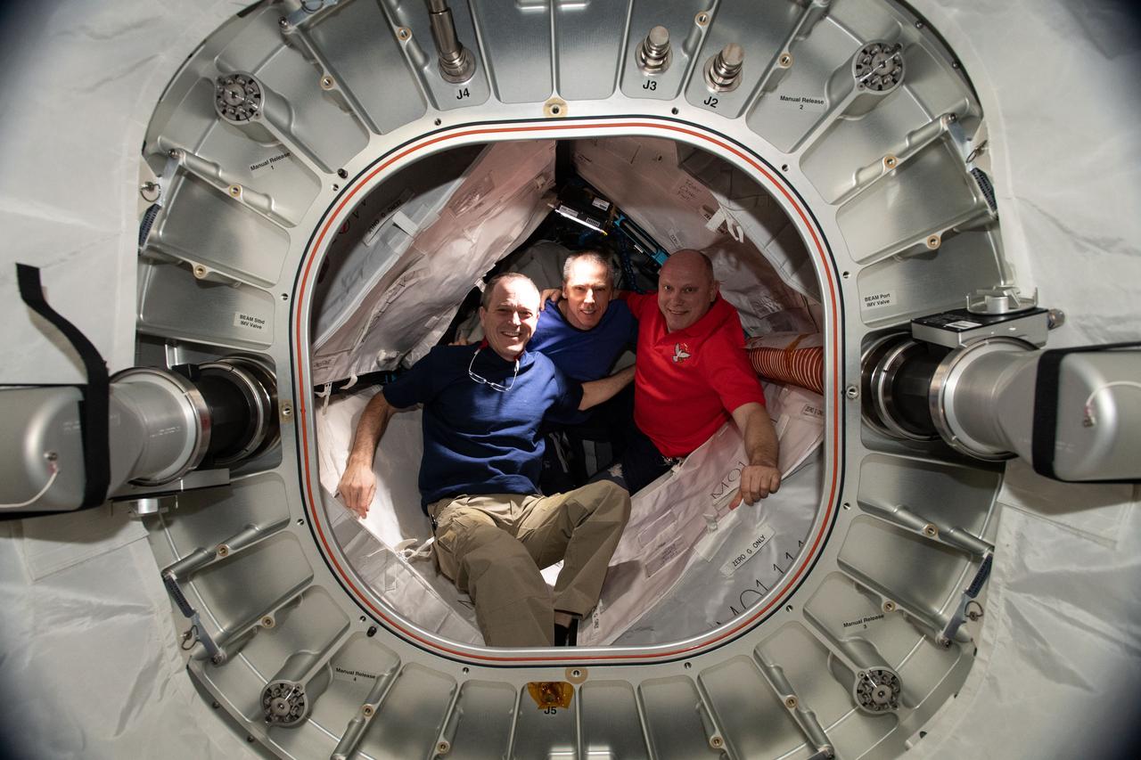 iss056e126552 (Aug. 2, 2018) ---  Expedition 55/56 crew members (from left) NASA astronauts Ricky Arnold and Drew Feustel and Roscosmos cosmonaut Oleg Artemyev, pose for a portrait inside the Bigelow Expandable Aerospace Module (BEAM). BEAM was installed on the International Space Station's Tranquility module on April 16, 2016 after being launched aboard the SpaceX Dragon cargo craft on April 8, 2016.